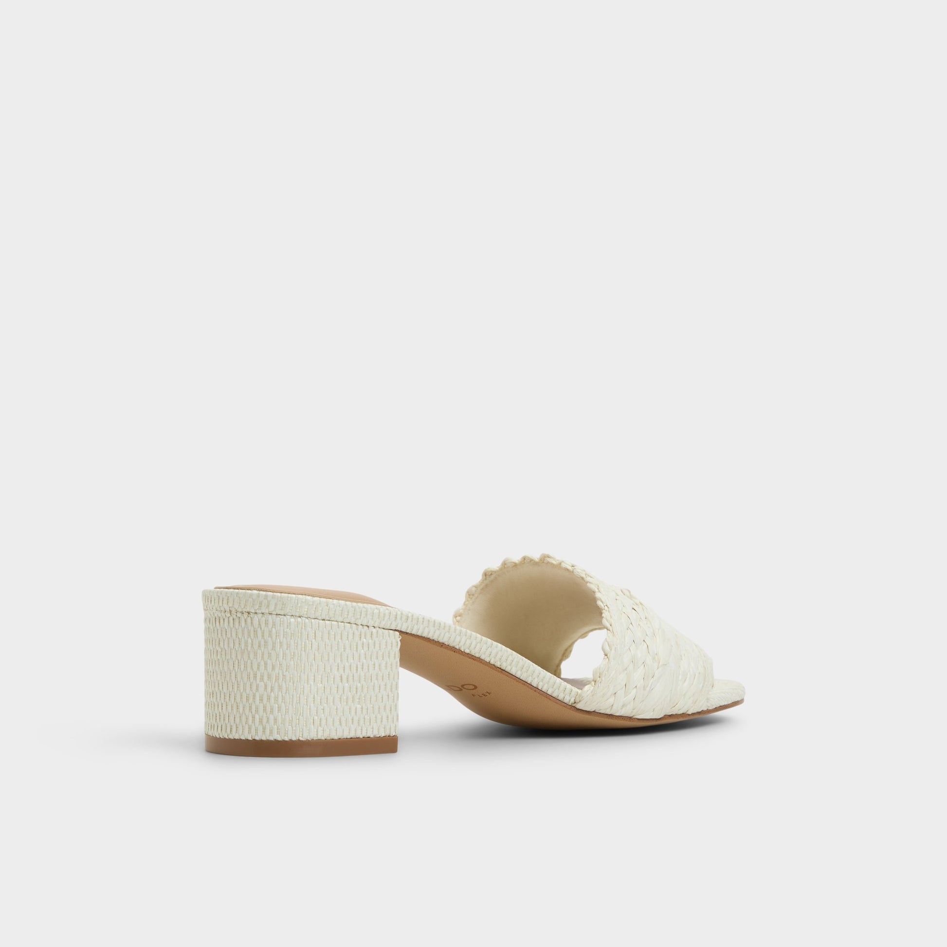 Three-quarter angle of White/Bone Claudina Heeled mule's back side