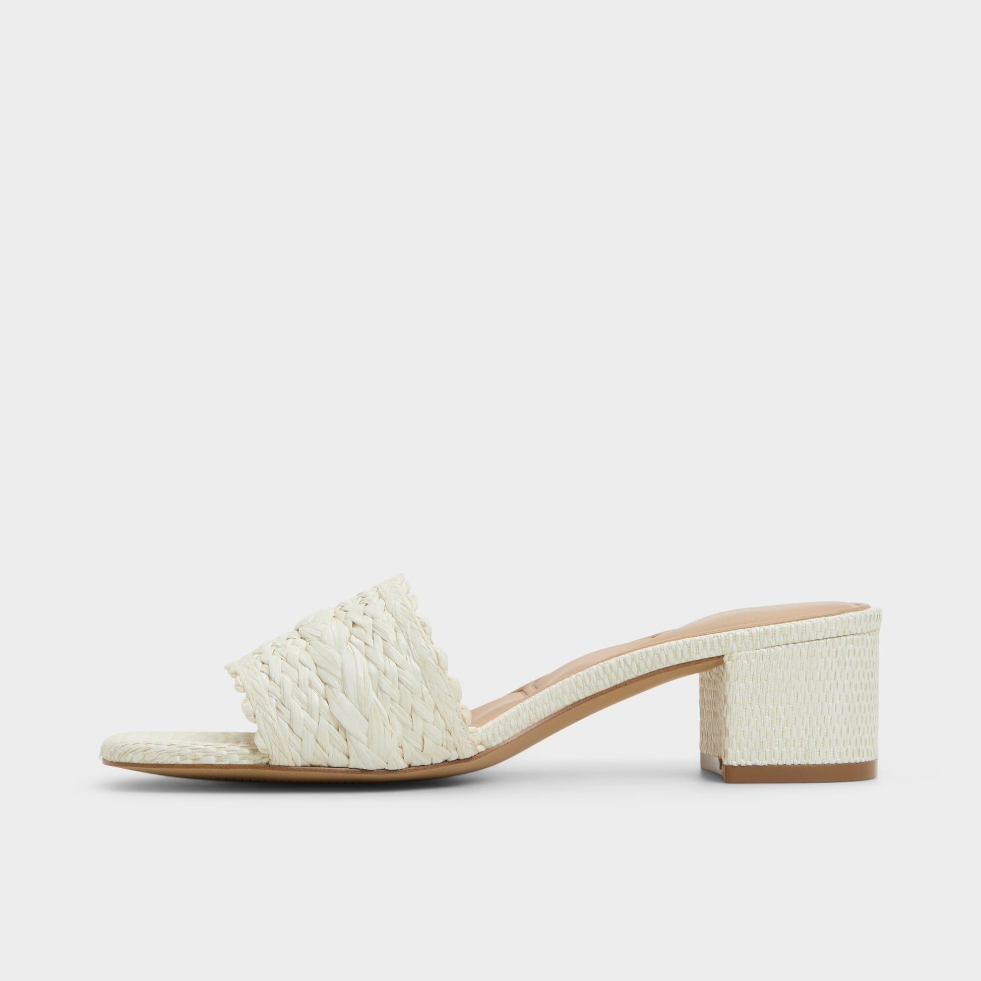 Side view of White/Bone Claudina Heeled mule