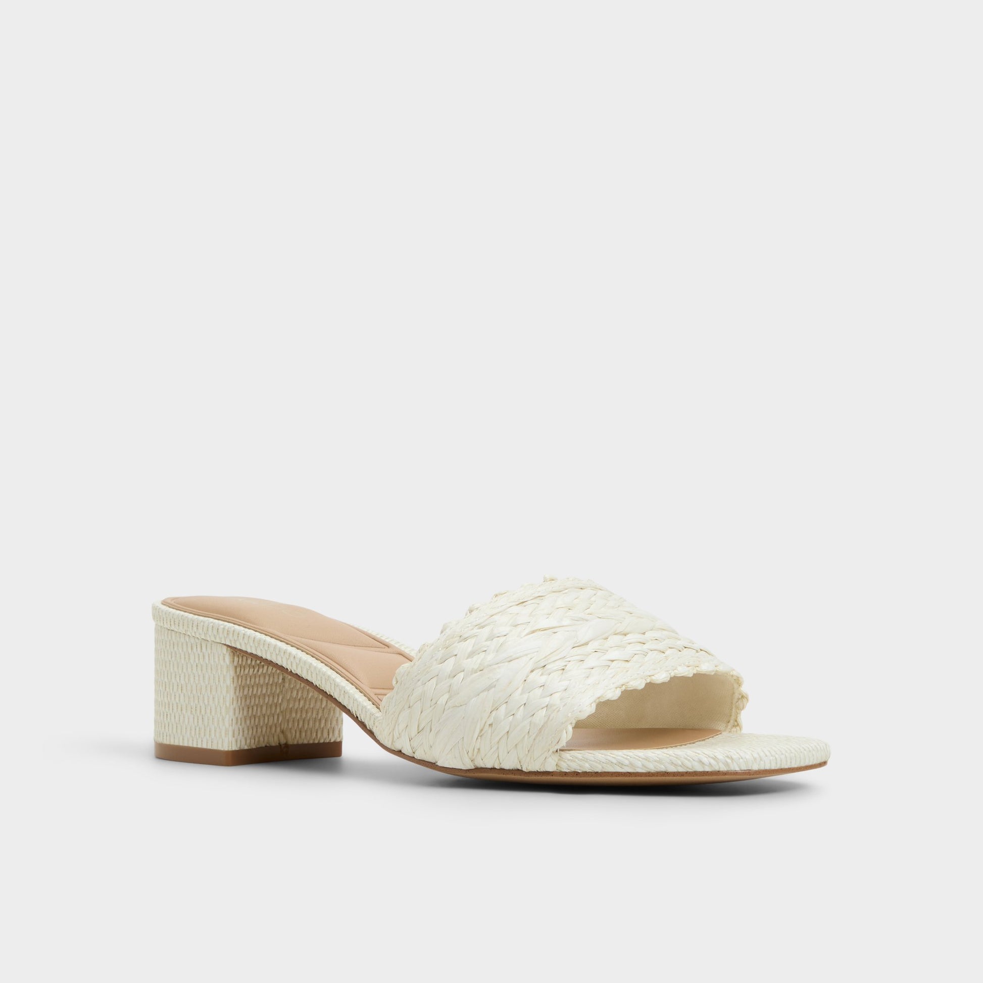 Three-quarter angle of White/Bone Claudina Heeled mule's front side