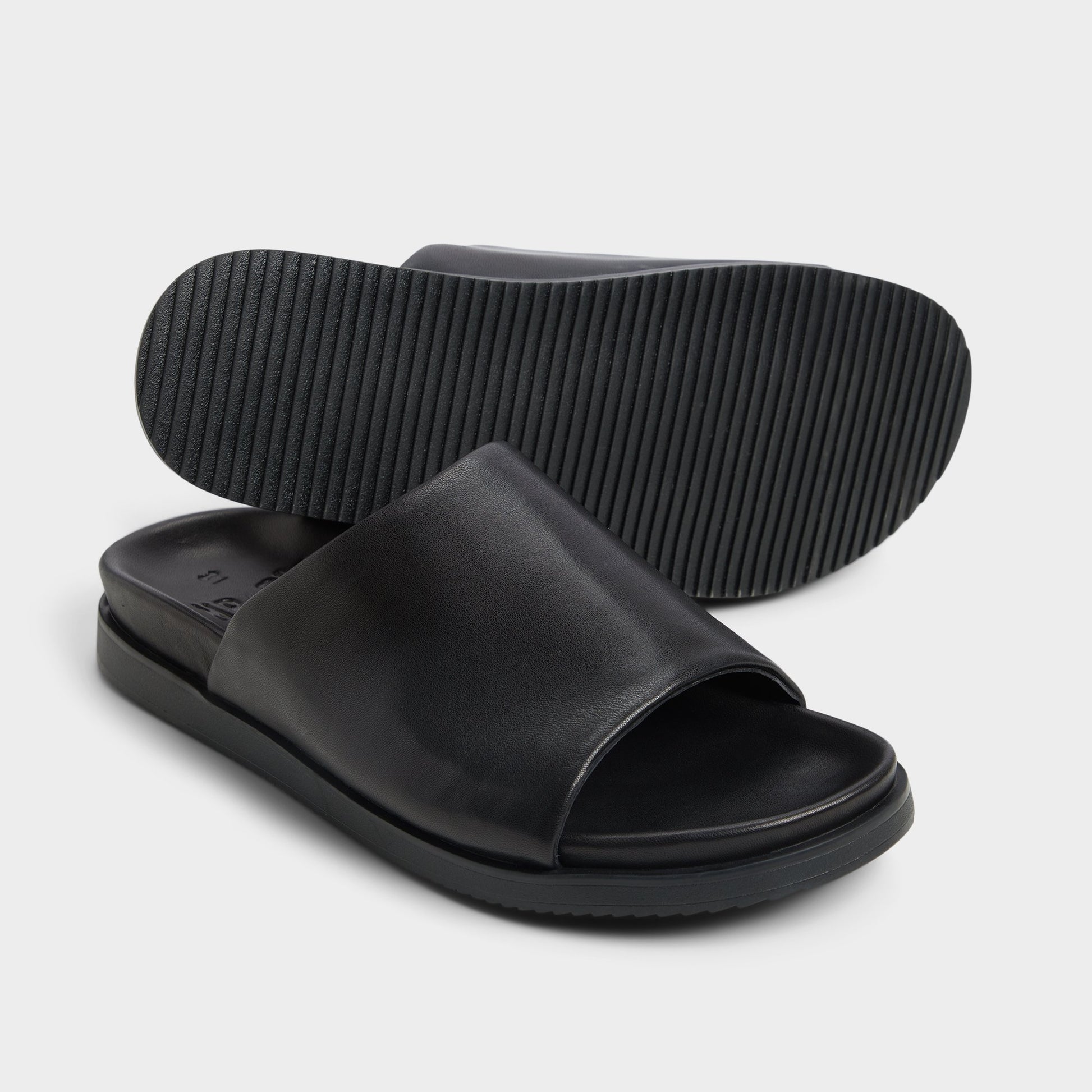 Highlighted view of a pair of Black Valor Slide sandals