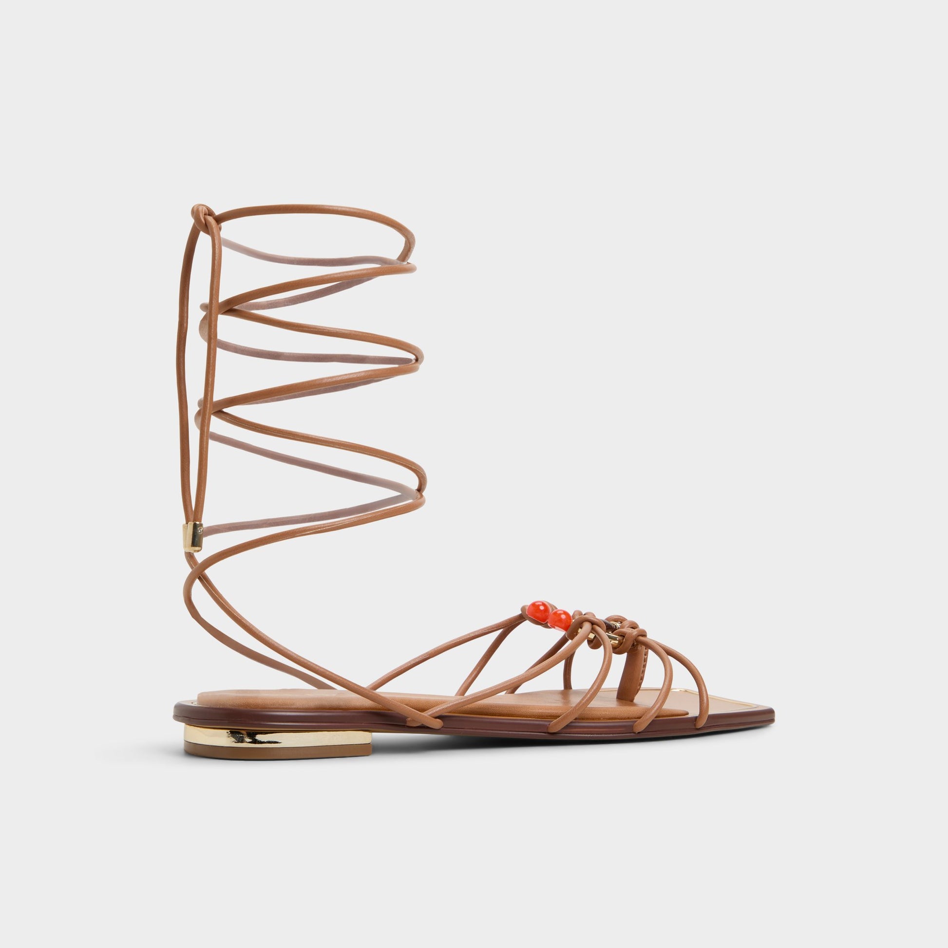 Three-quarter angle of Medium Brown Nirena Strappy flat sandal's back side
