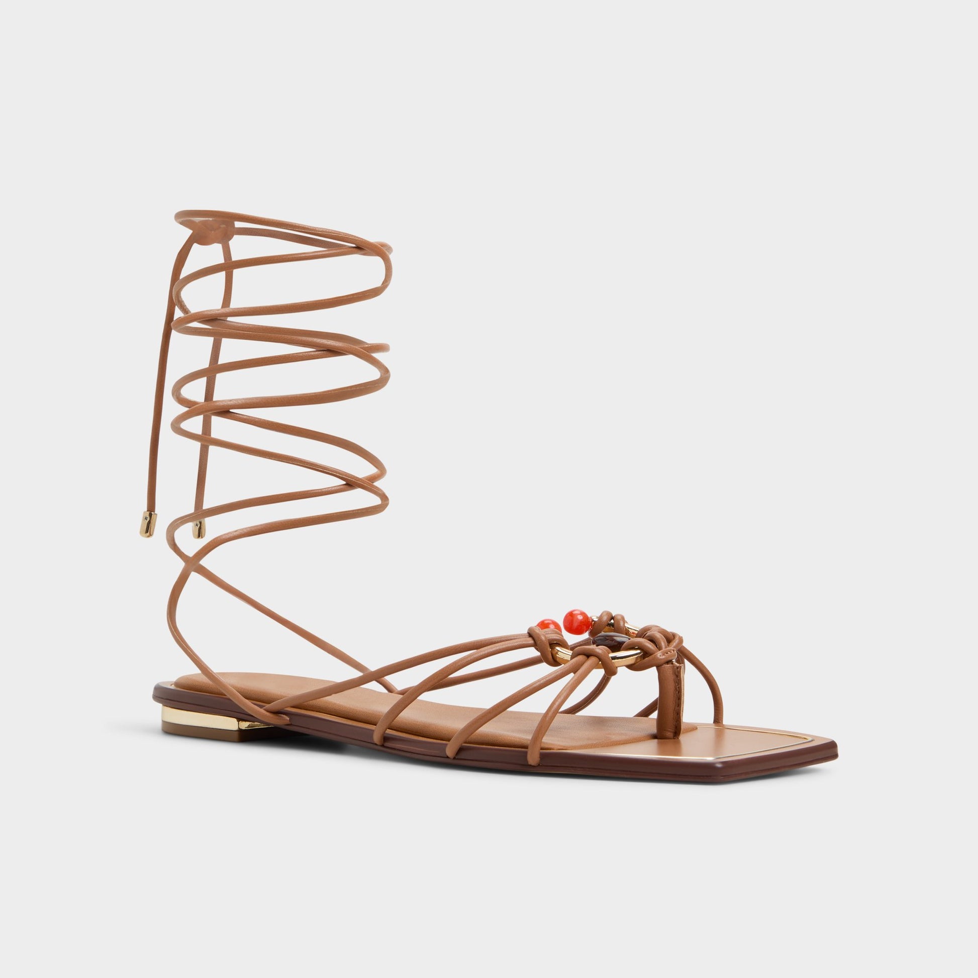 Three-quarter angle of Medium Brown Nirena Strappy flat sandal's front side