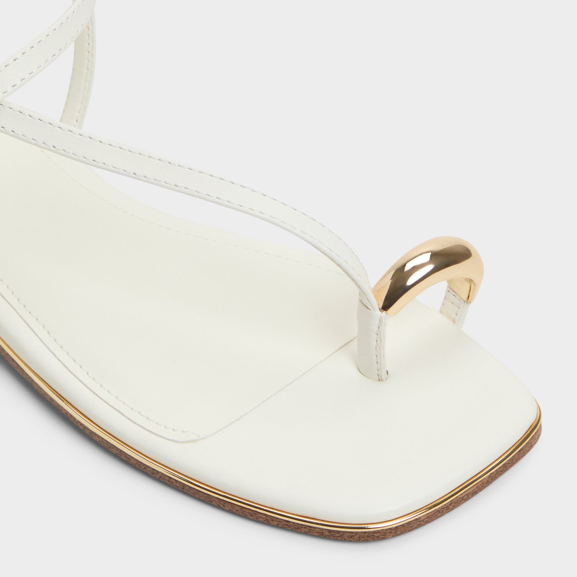Close-up of the White Jomalina Strappy flat sandal