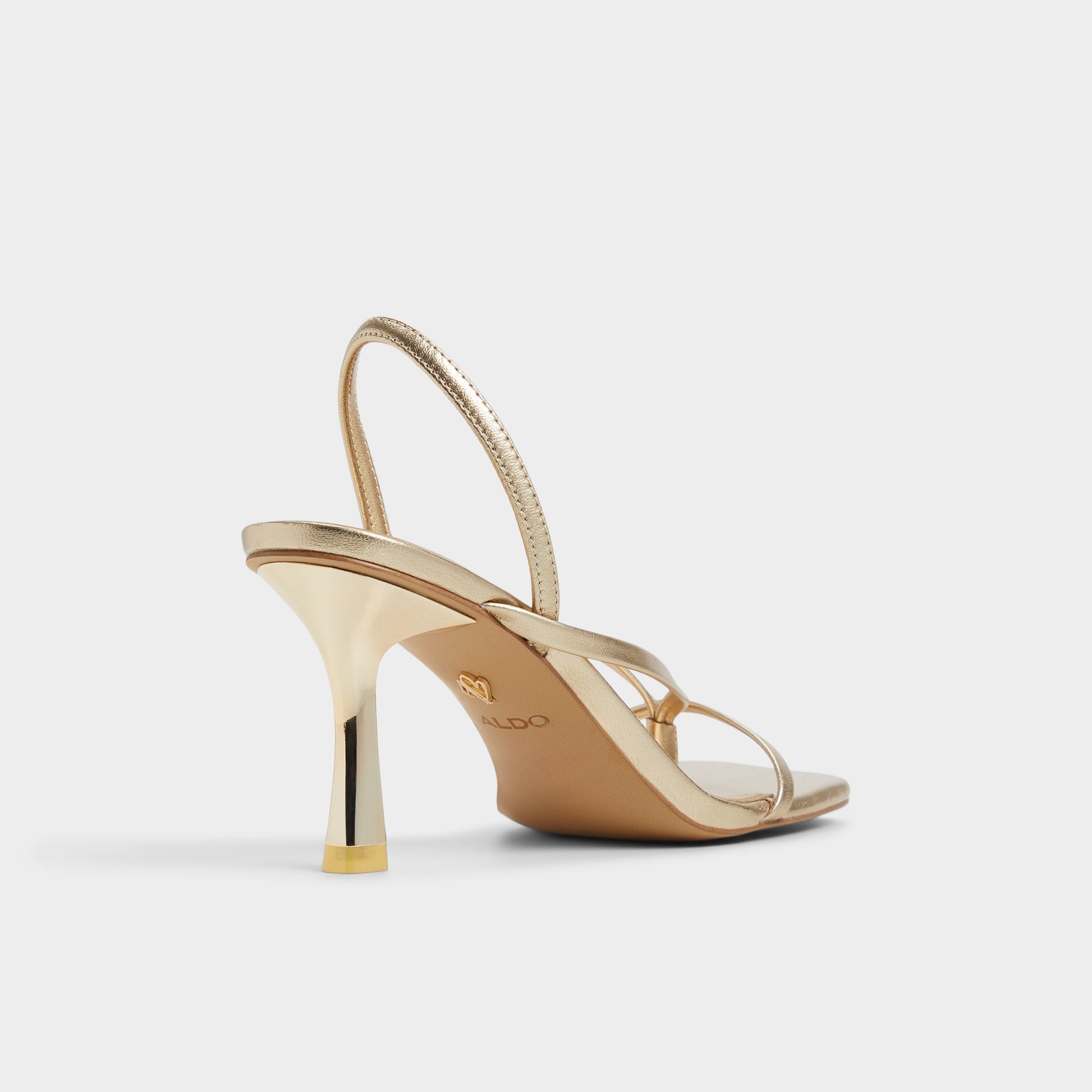Three-quarter angle of Gold Riva Sling back heeled sandal's back side
