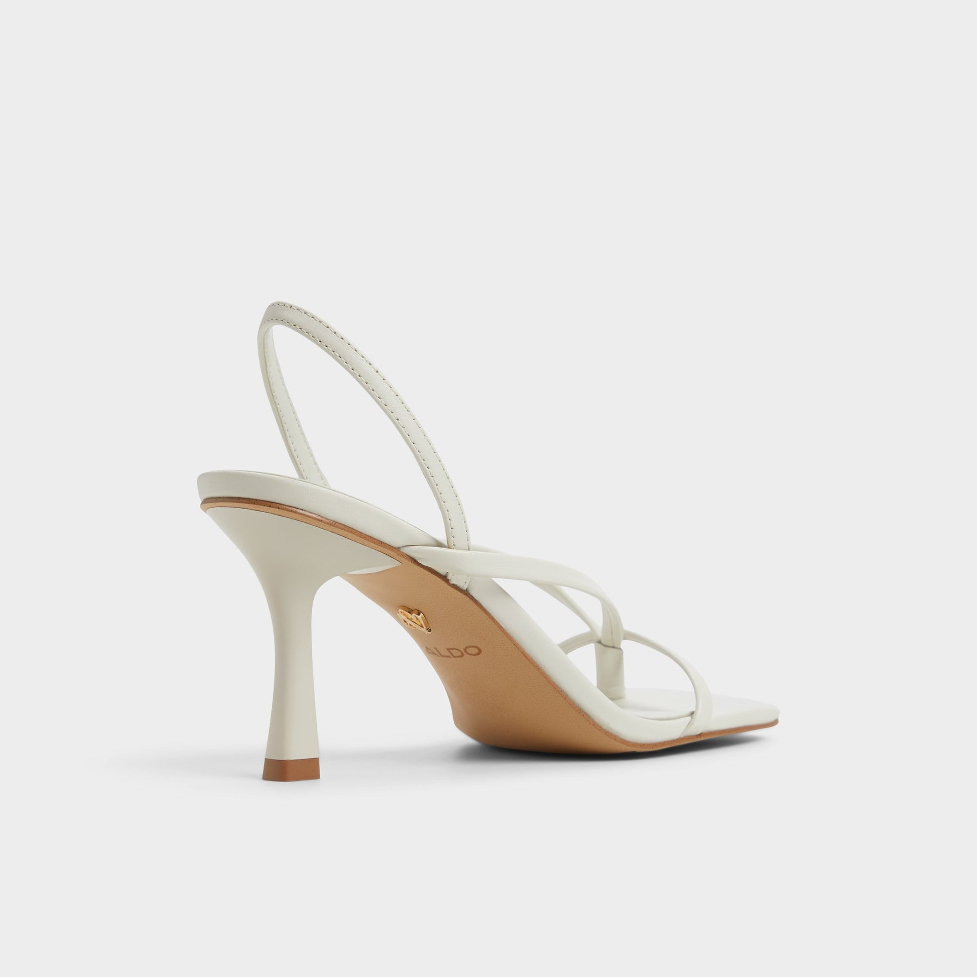 Three-quarter angle of White/Bone Riva Sling back heeled sandal's back side