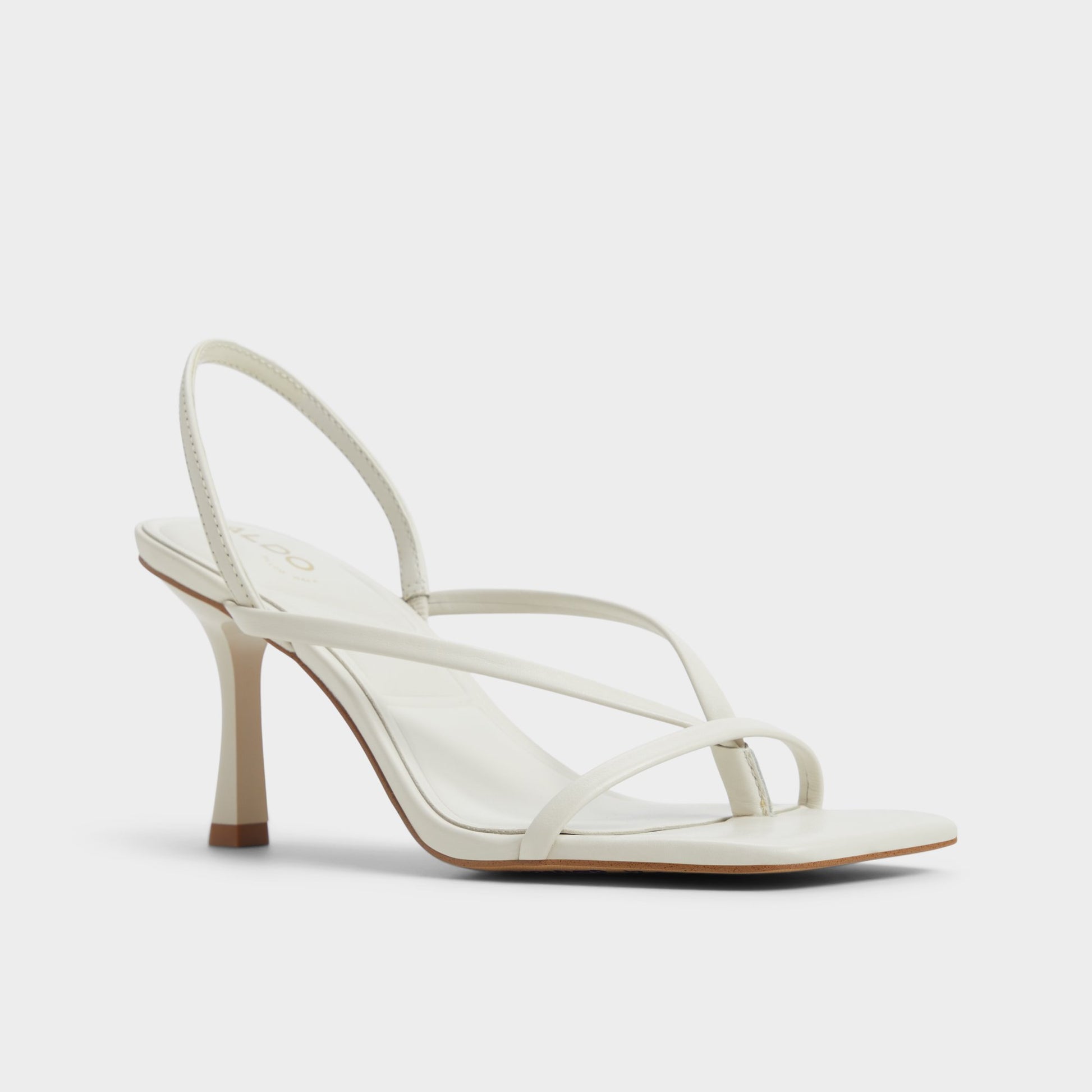 Three-quarter angle of White/Bone Riva Sling back heeled sandal's front side