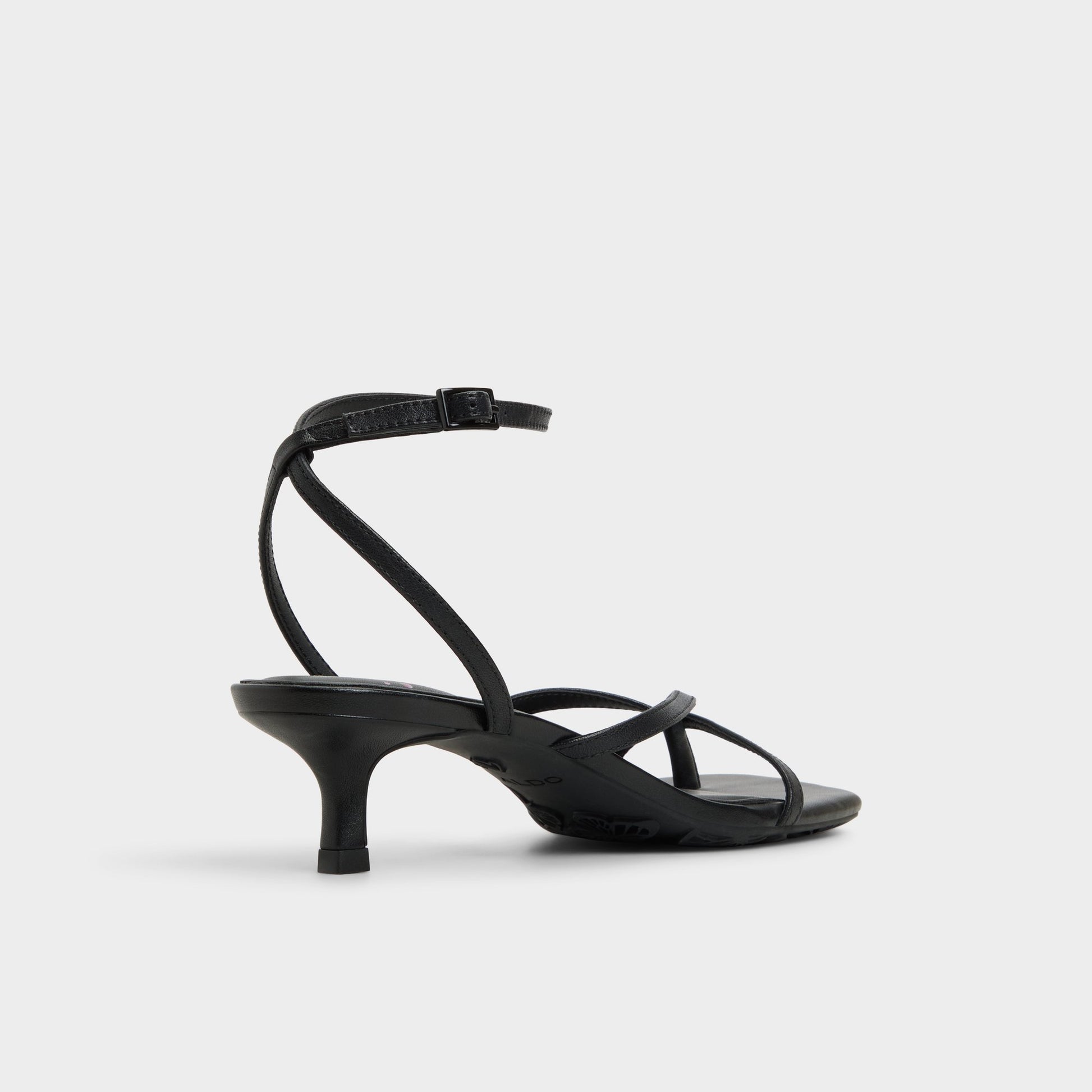 Three-quarter angle of Black Soffie Strappy heeled sandal's back side