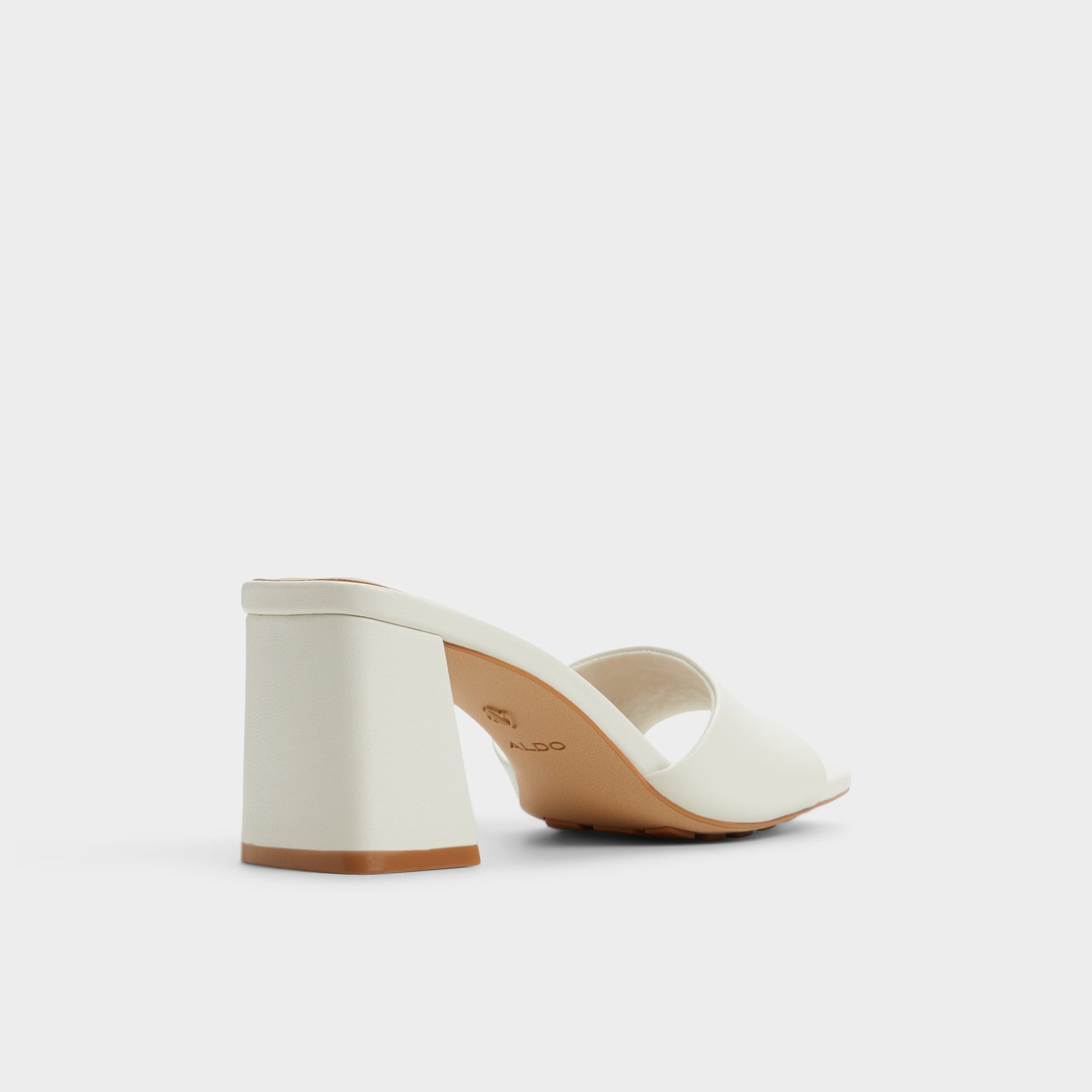 Three-quarter angle of White Tisha Heeled mule's back side