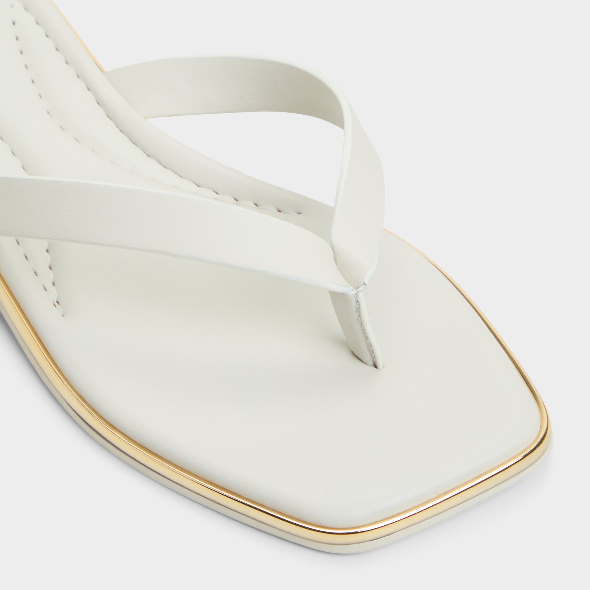Close-up of the White/Bone Theao Flip flop