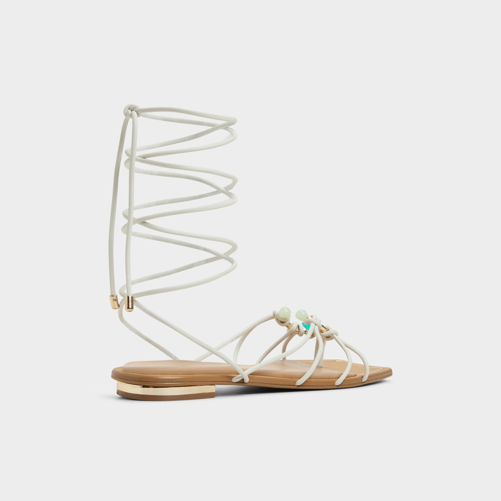 Three-quarter angle of White/Bone Nirena Strappy flat sandal's back side