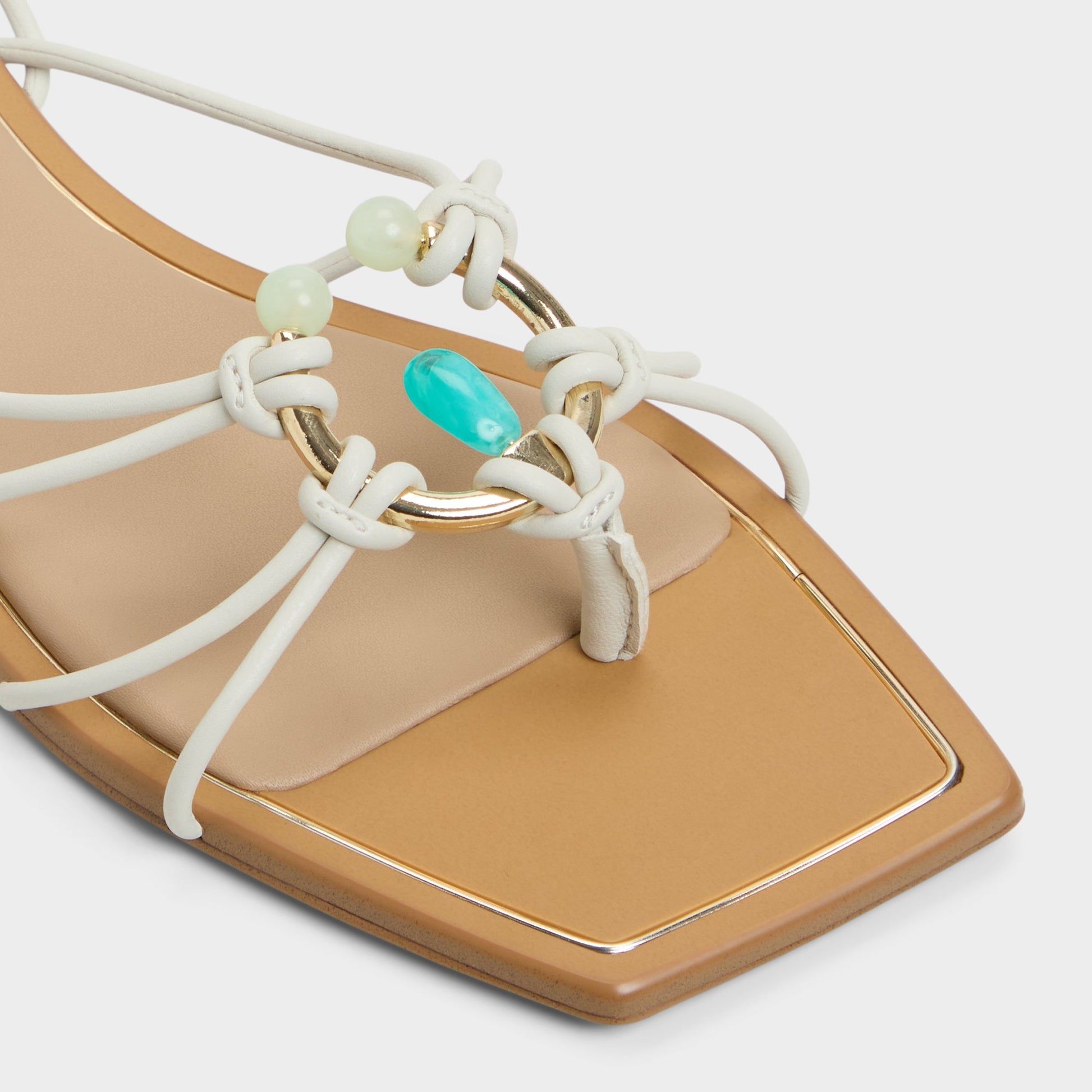 Close-up of the White/Bone Nirena Strappy flat sandal