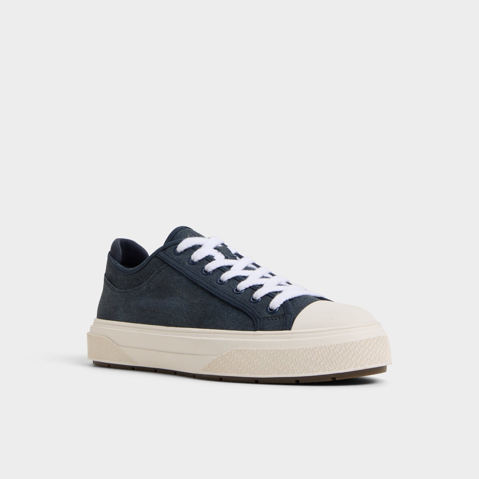 Three-quarter angle of Navy Colin Low top sneaker's front side