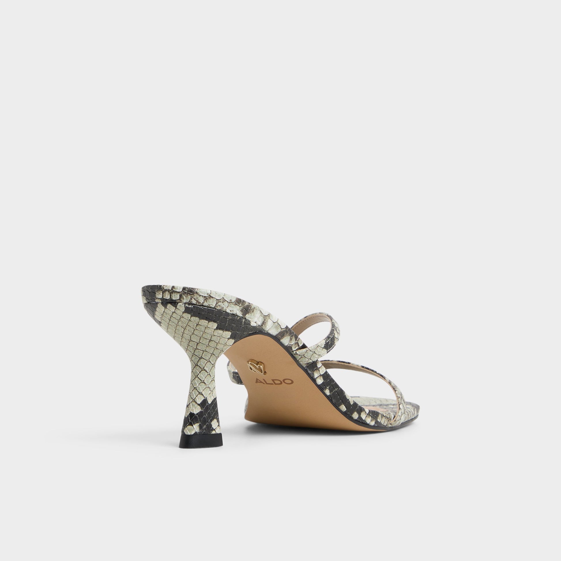 Three-quarter angle of White/Black Calypsa Strappy heeled sandal's back side