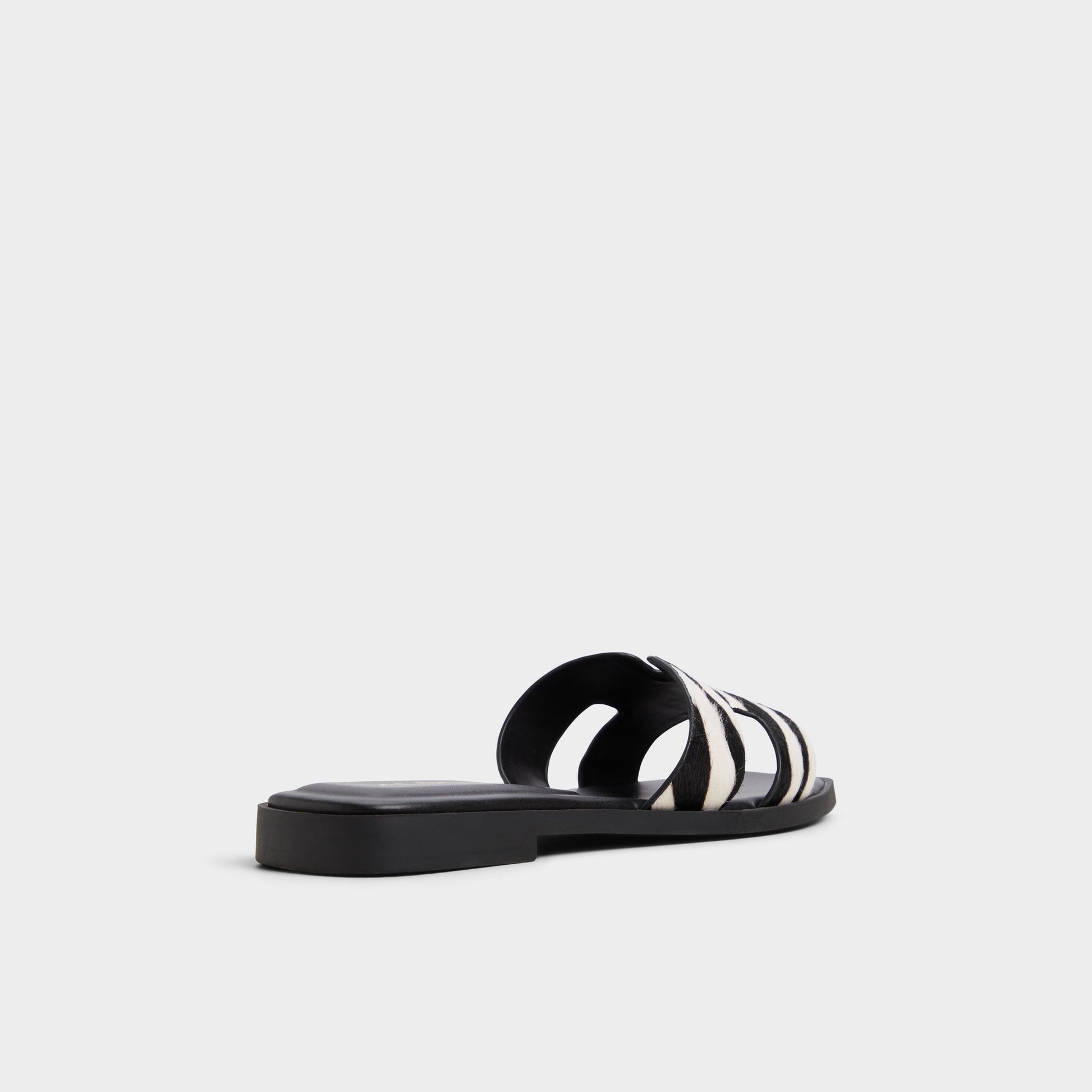Three-quarter angle of White/Black Itsandal Slide sandal's back side