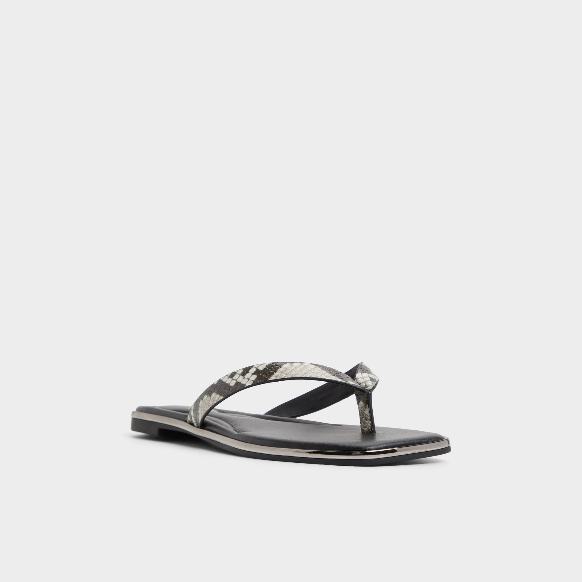 Three-quarter angle of White/Black Theao Flip flop's front side