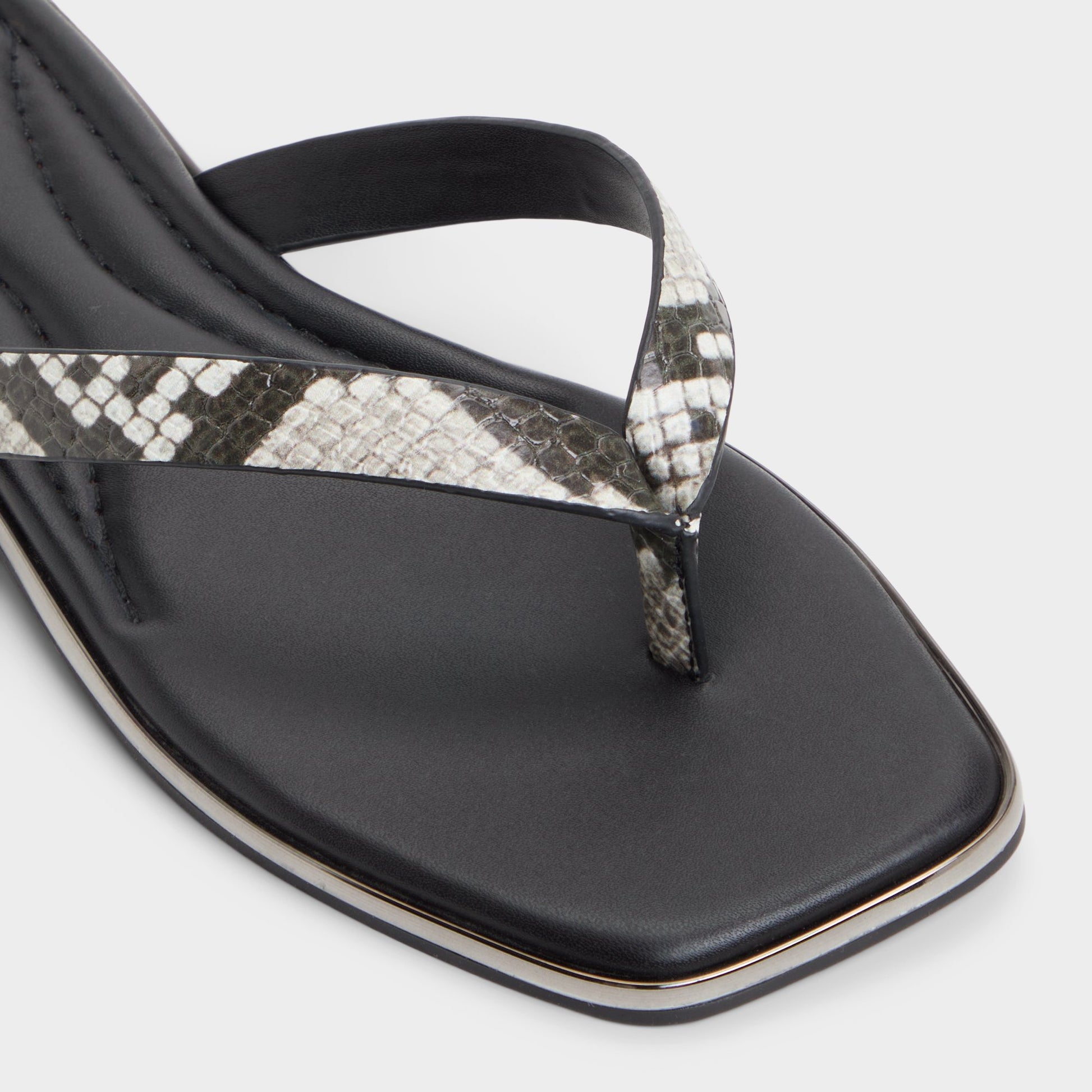 Close-up of the White/Black Theao Flip flop