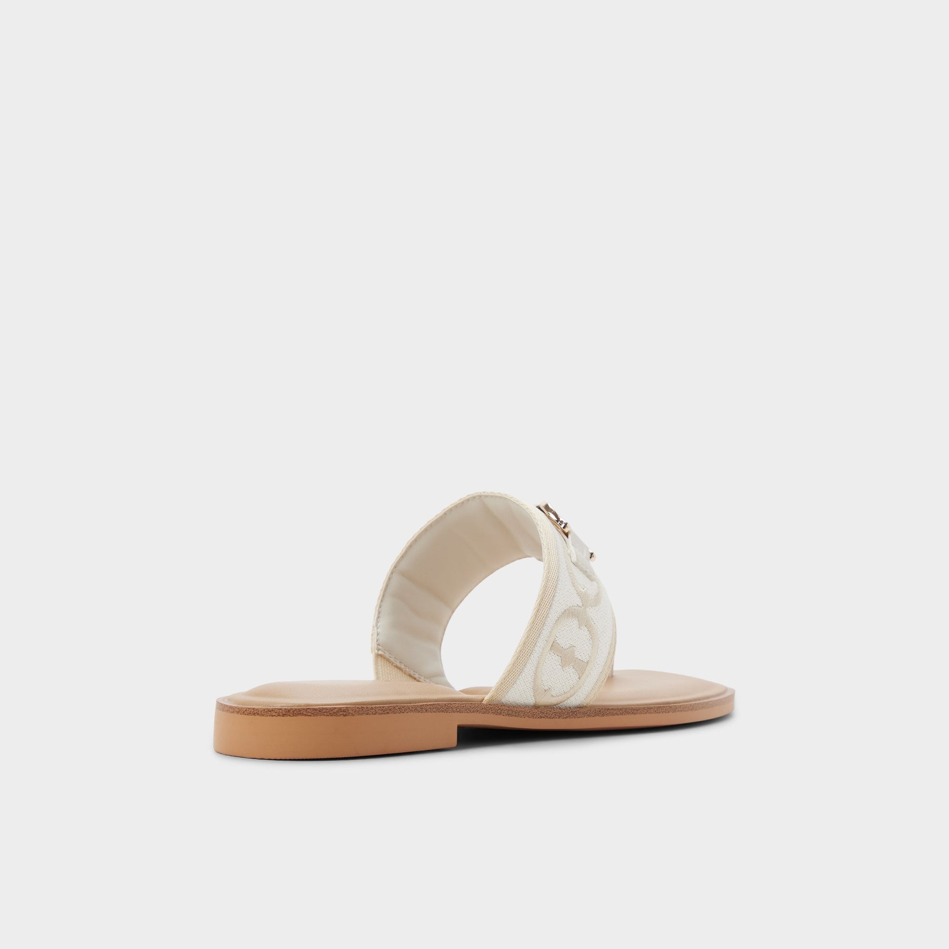 Three-quarter angle of White/Bone Coralynna T-strap sandal's back side