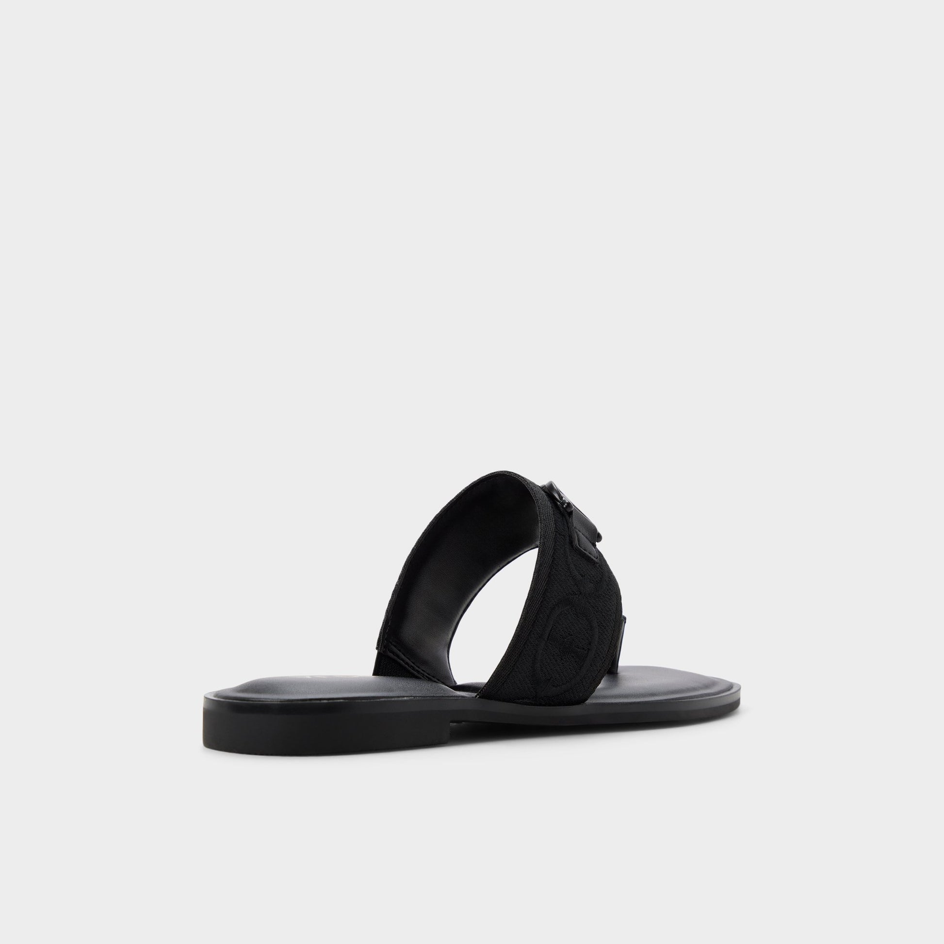 Three-quarter angle of Black Coralynna T-strap sandal's back side