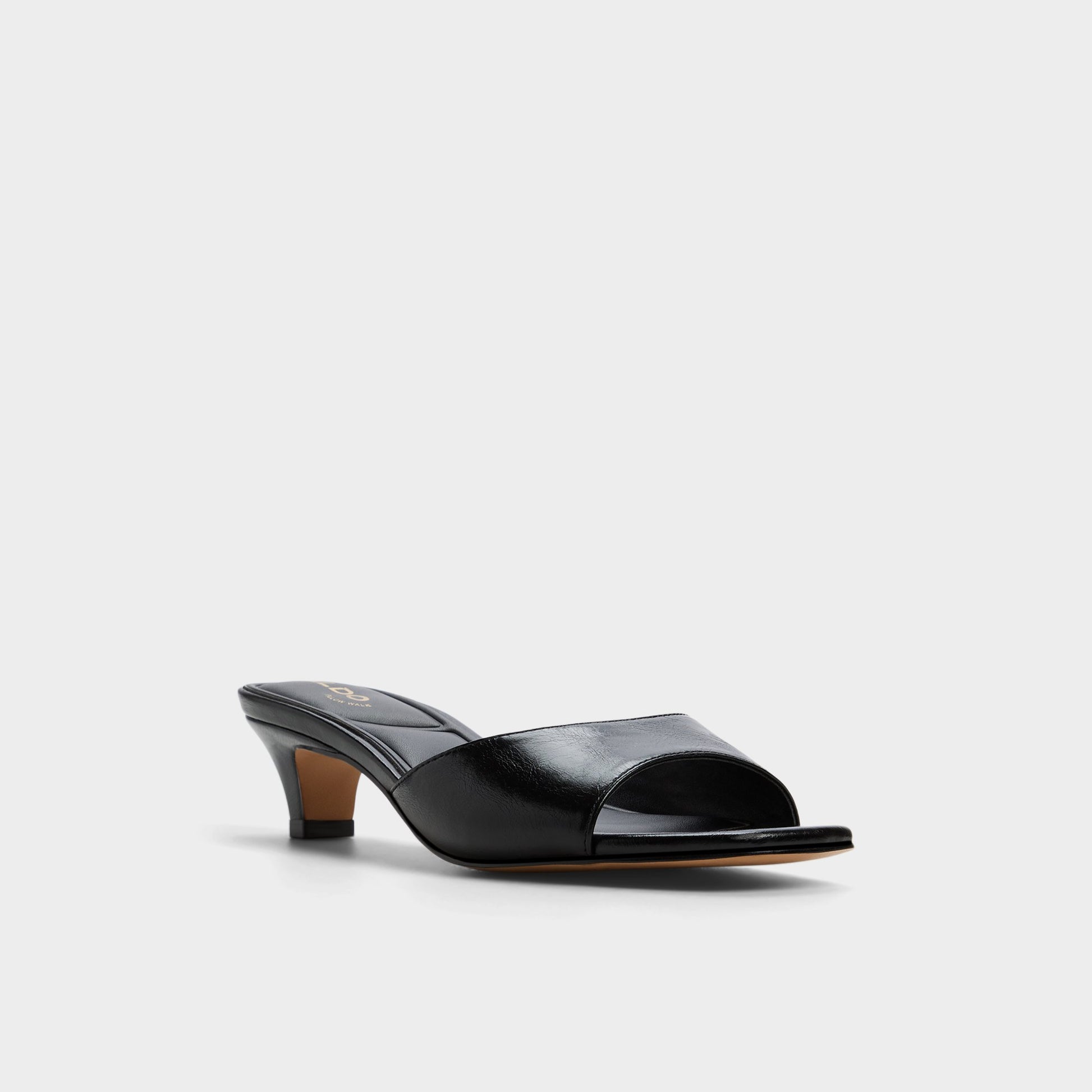 Three-quarter angle of Black Haeden Heeled mule's front side