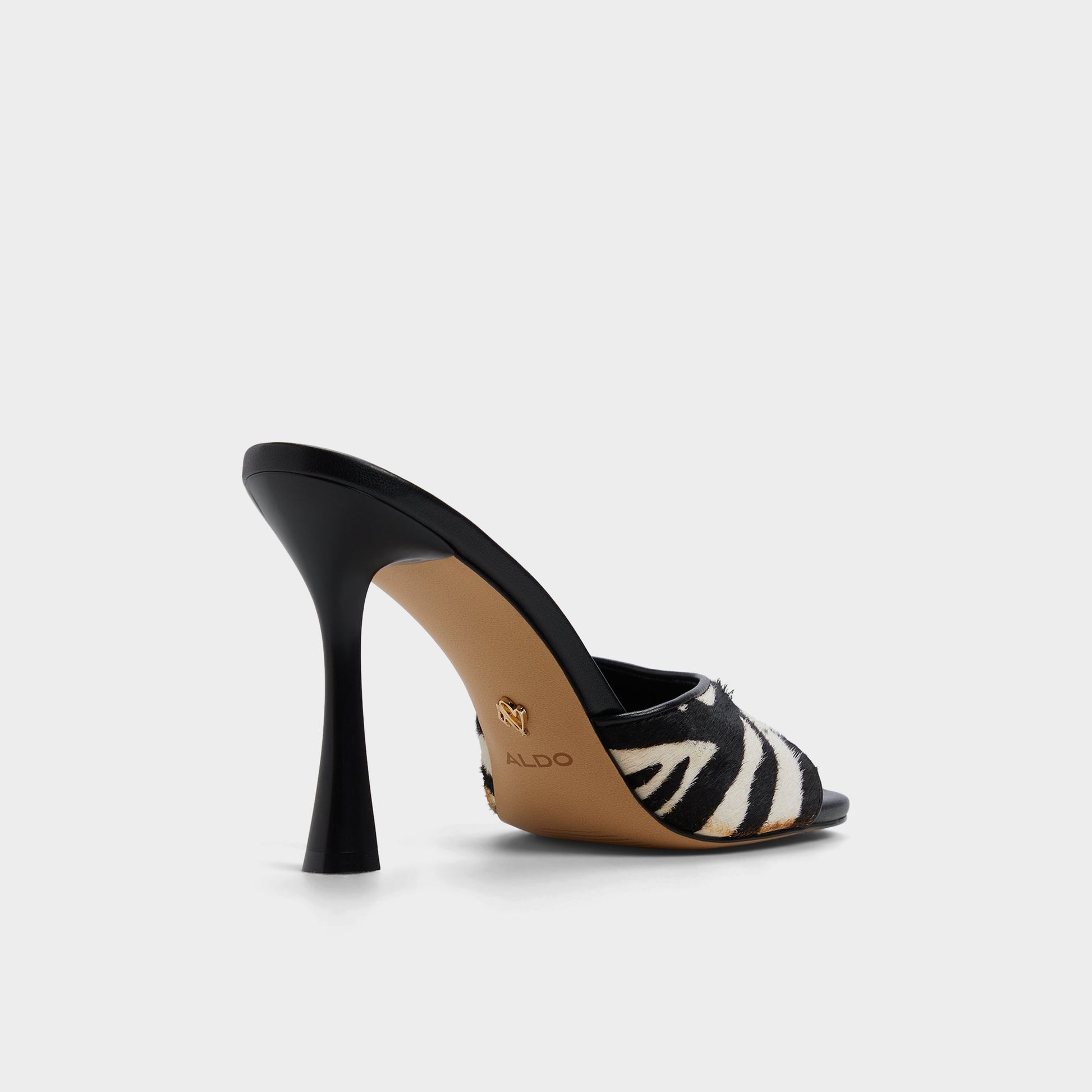 Three-quarter angle of White/Black Evadalia Heeled mule's back side
