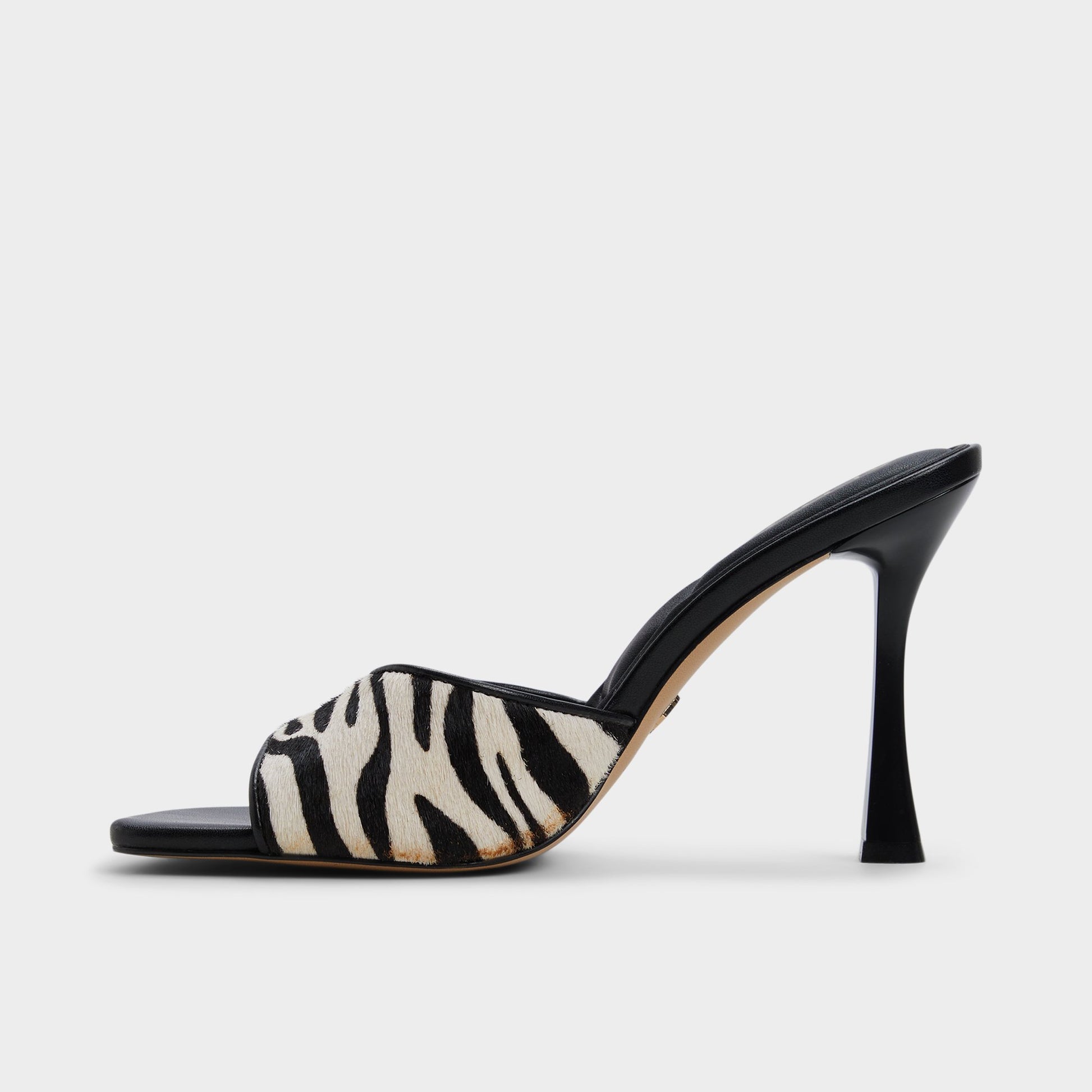 Side view of White/Black Evadalia Heeled mule