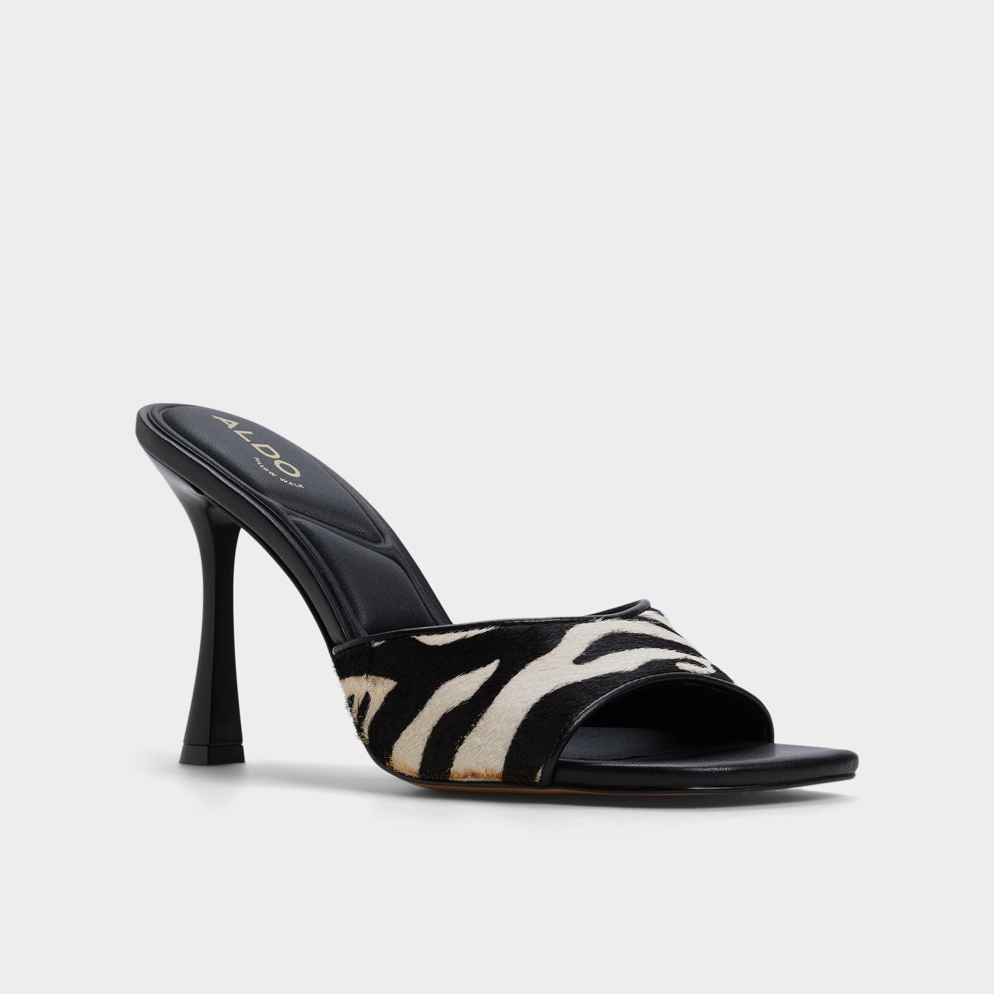 Three-quarter angle of White/Black Evadalia Heeled mule's front side
