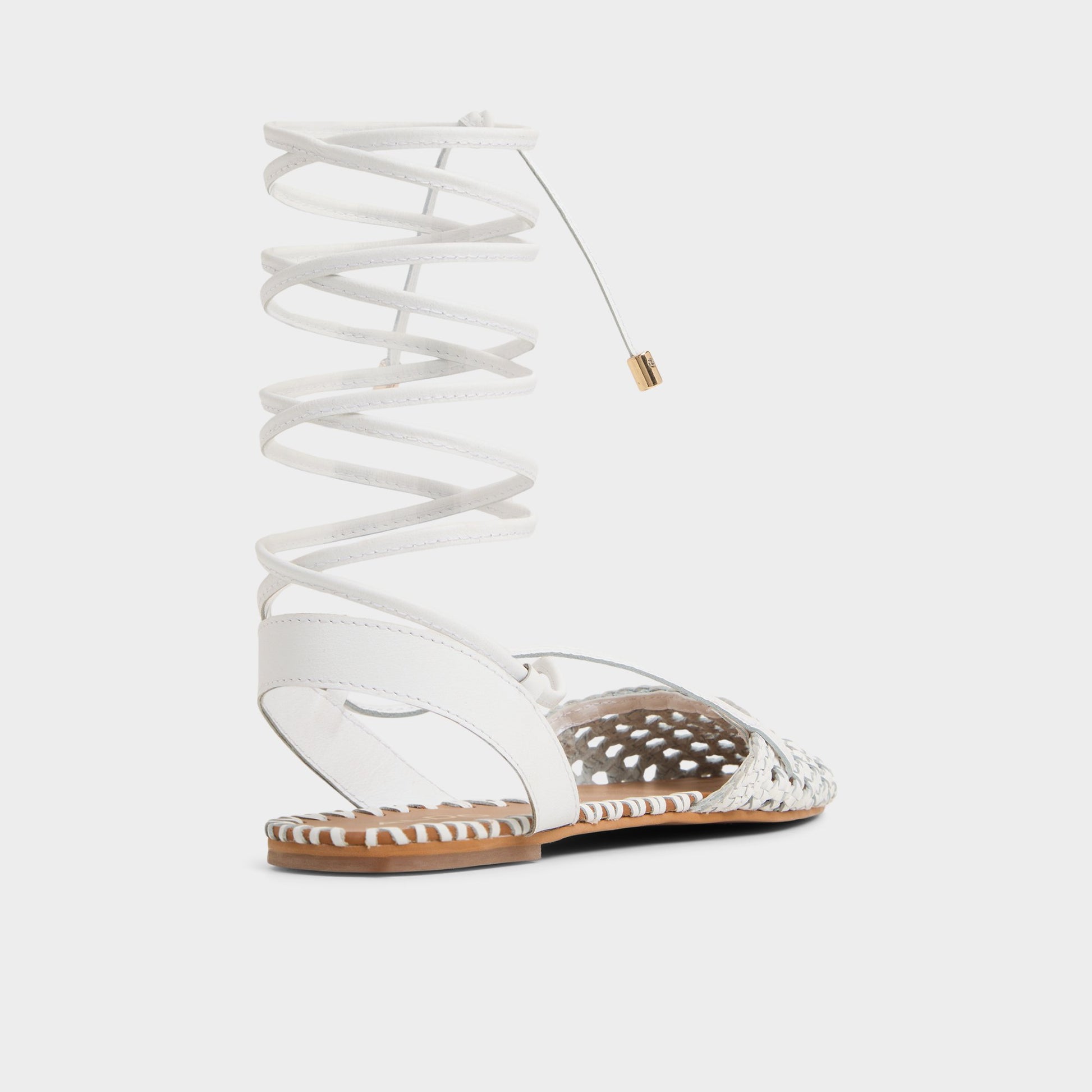 Three-quarter angle of White/Bone Dragostee Strappy flat sandal's back side