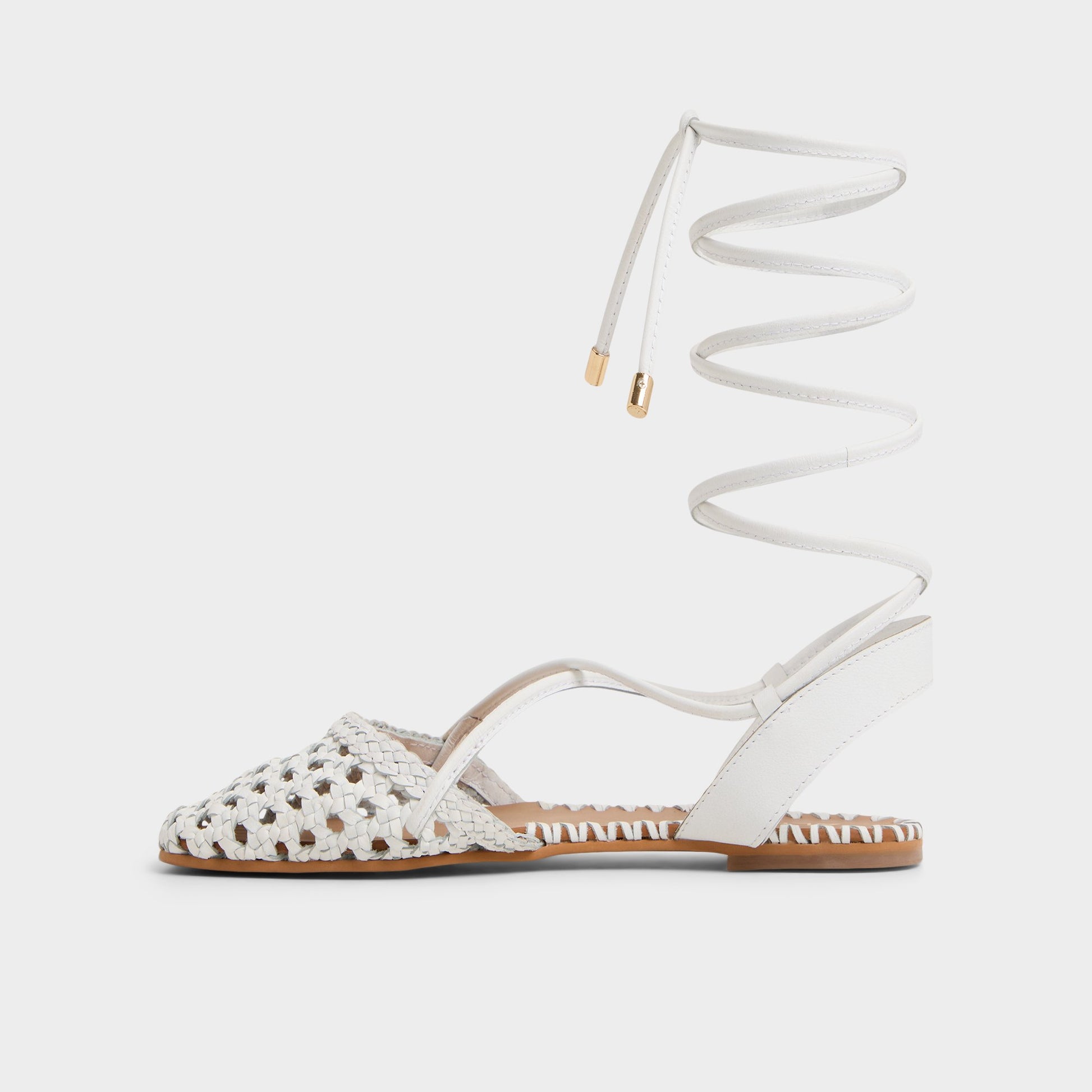 Side view of White/Bone Dragostee Strappy flat sandal