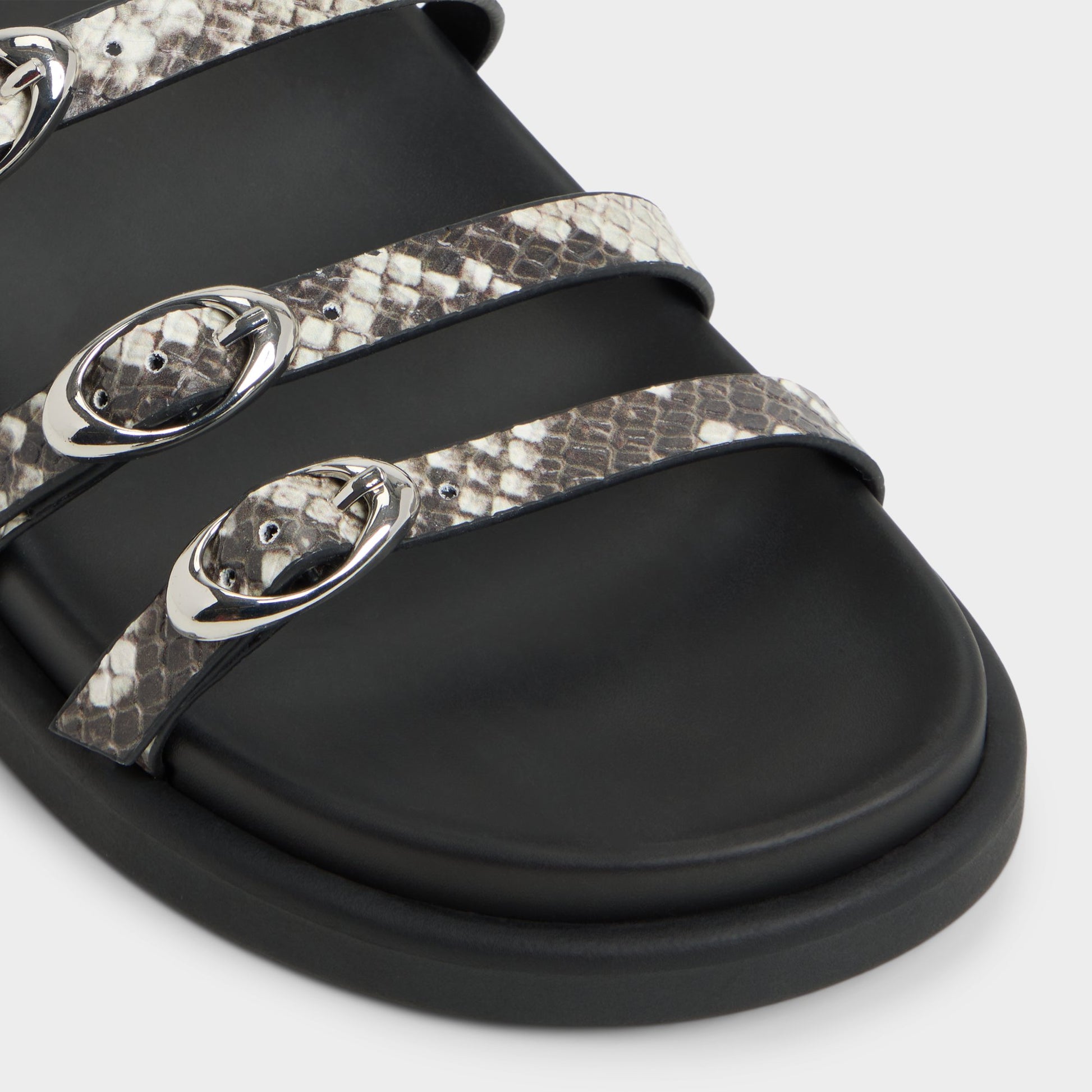 Close-up of the White/Black Zephyra Footbed sandal