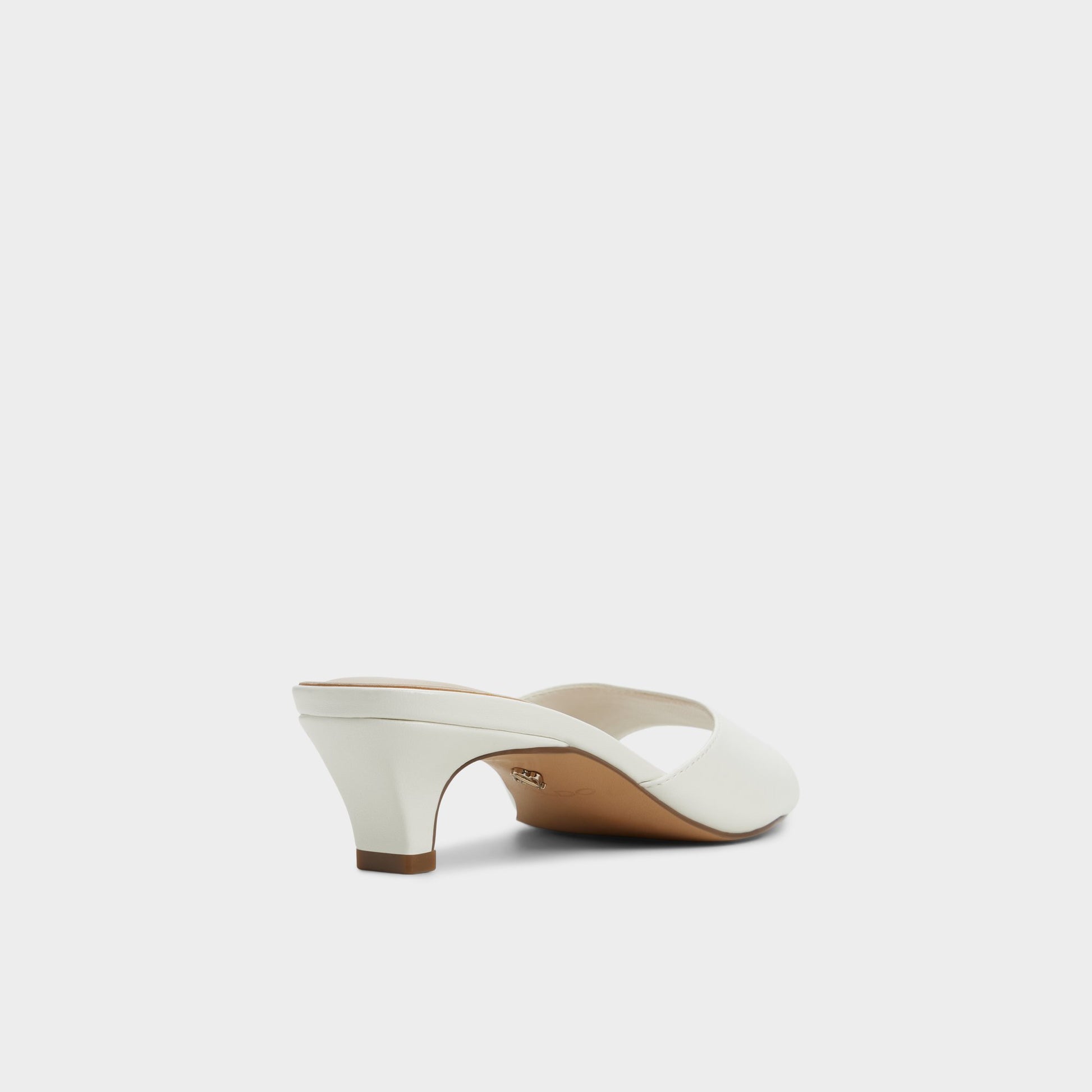 Three-quarter angle of White Haeden Heeled mule's back side