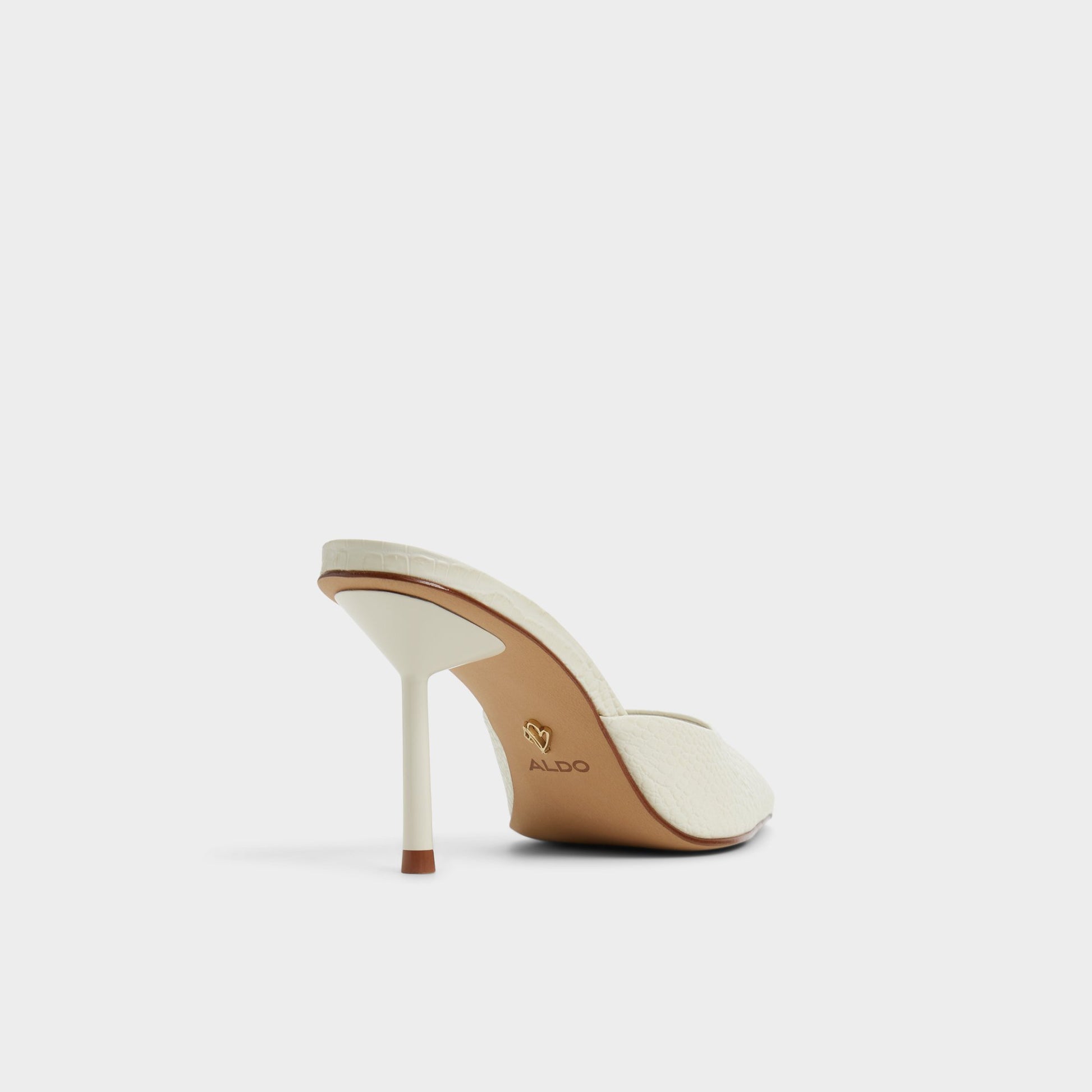 Three-quarter angle of White/Bone Beatrixy Heeled mule's back side