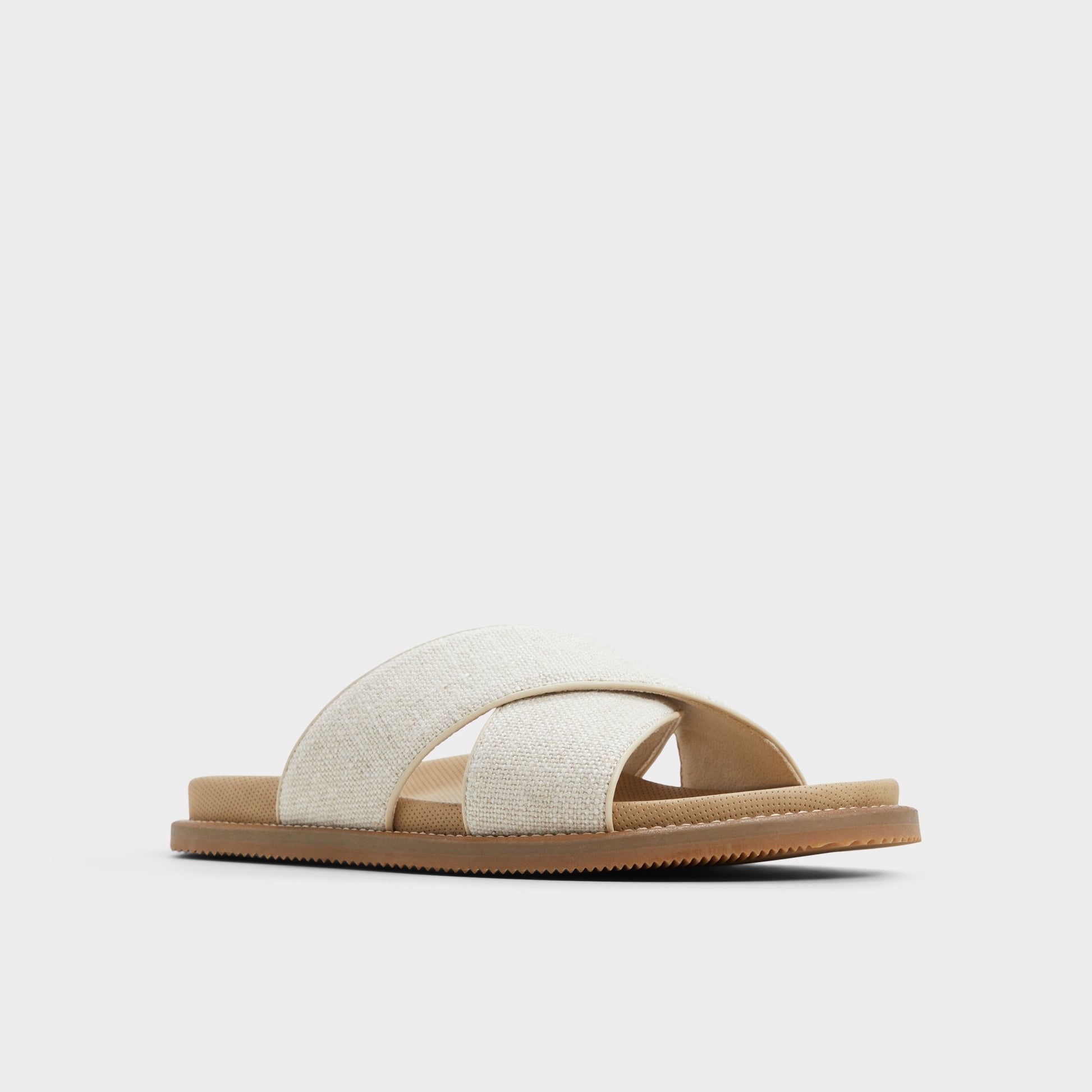 Three-quarter angle of Open Beige Marrin Slide sandal's front side