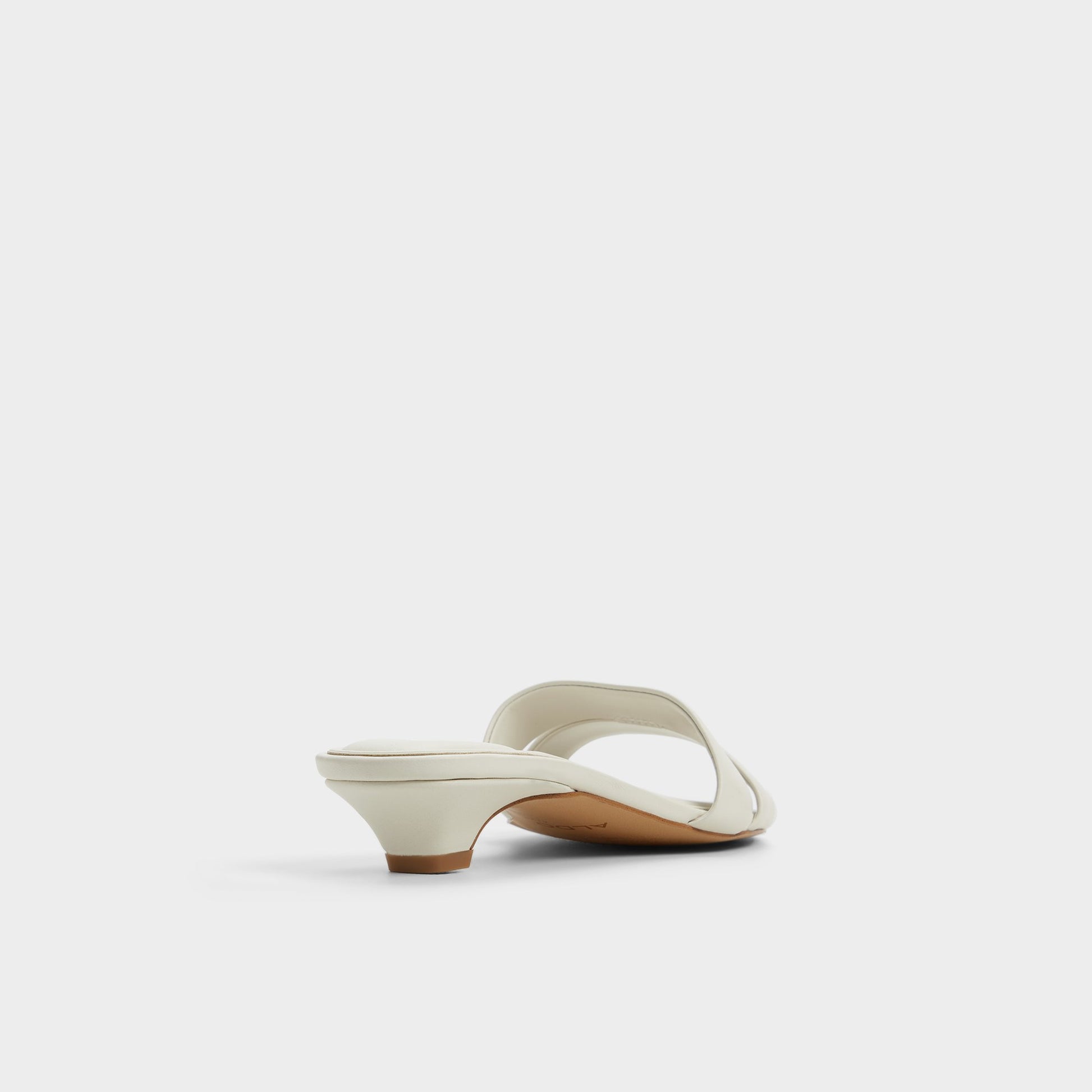 Three-quarter angle of White/Bone Scarletta Heeled mule's back side
