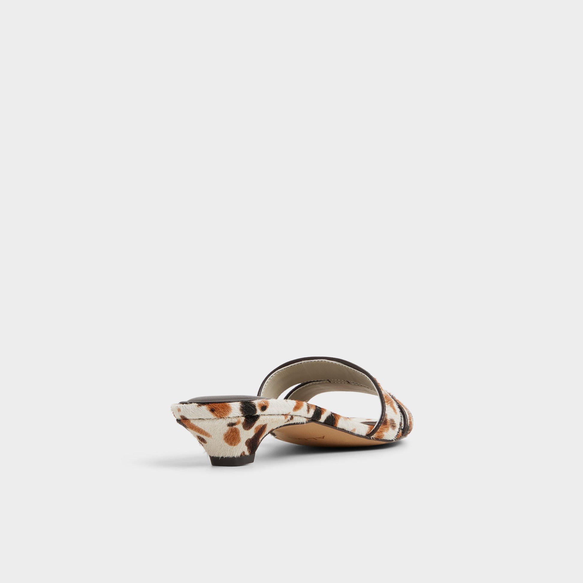 Three-quarter angle of White/Black Scarletta Heeled mule's back side