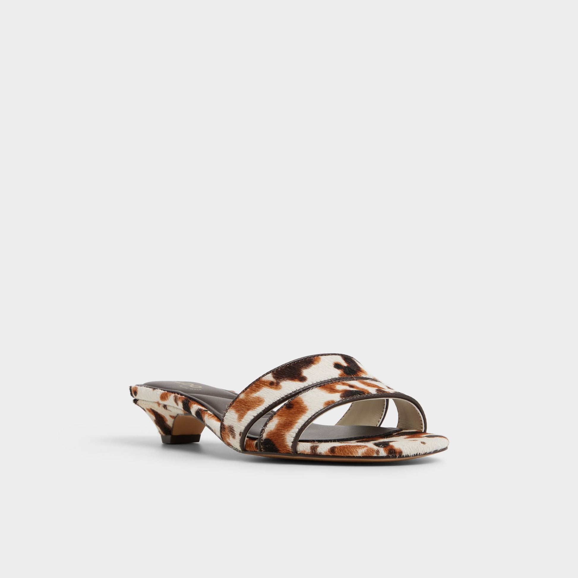 Three-quarter angle of White/Black Scarletta Heeled mule's front side
