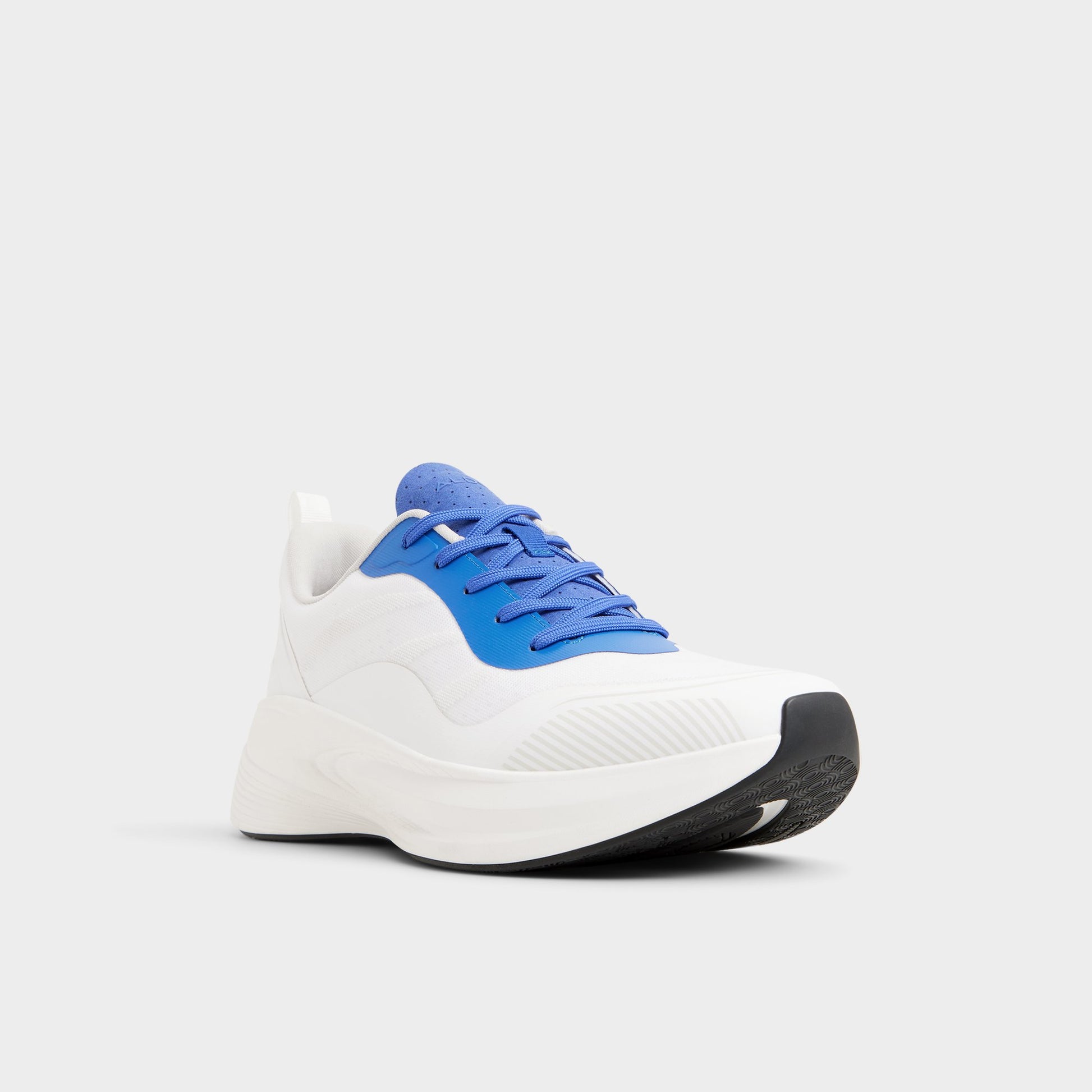 Three-quarter angle of White/Blue Pillowsnkr-m Jogger sneaker's front side
