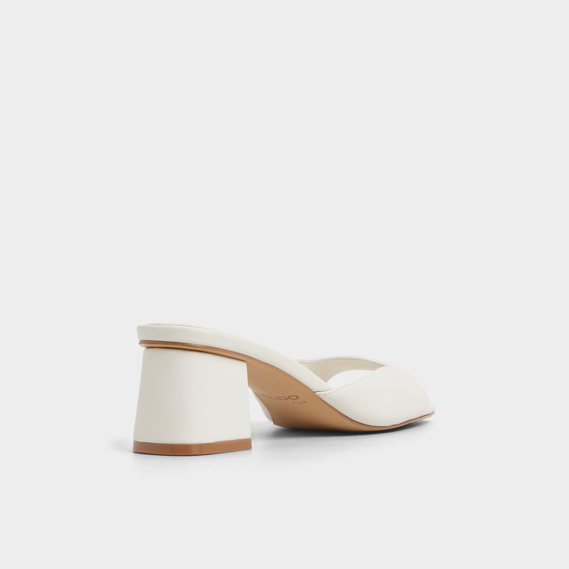Three-quarter angle of White/Bone Aneky Heeled mule's back side