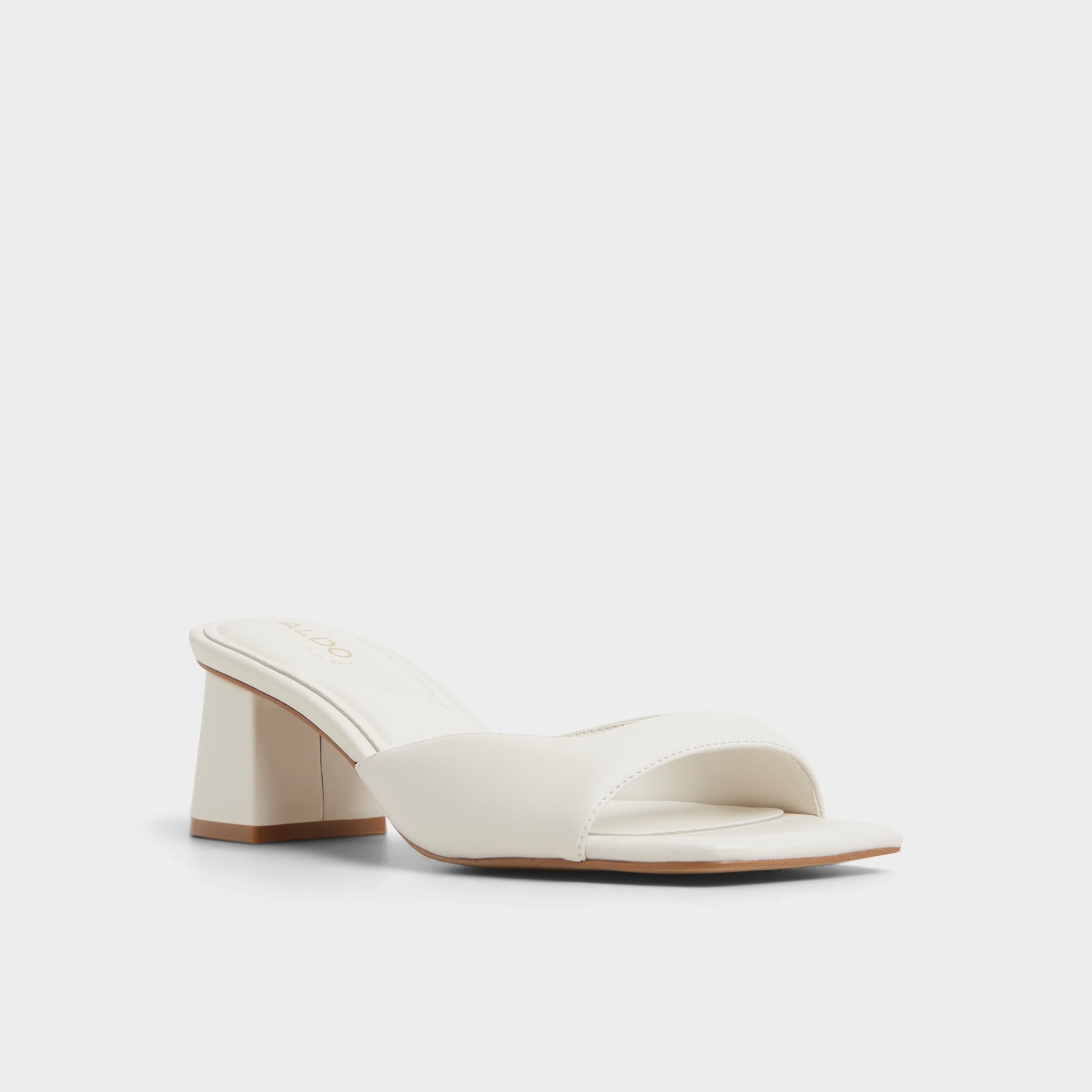 Three-quarter angle of White/Bone Aneky Heeled mule's front side