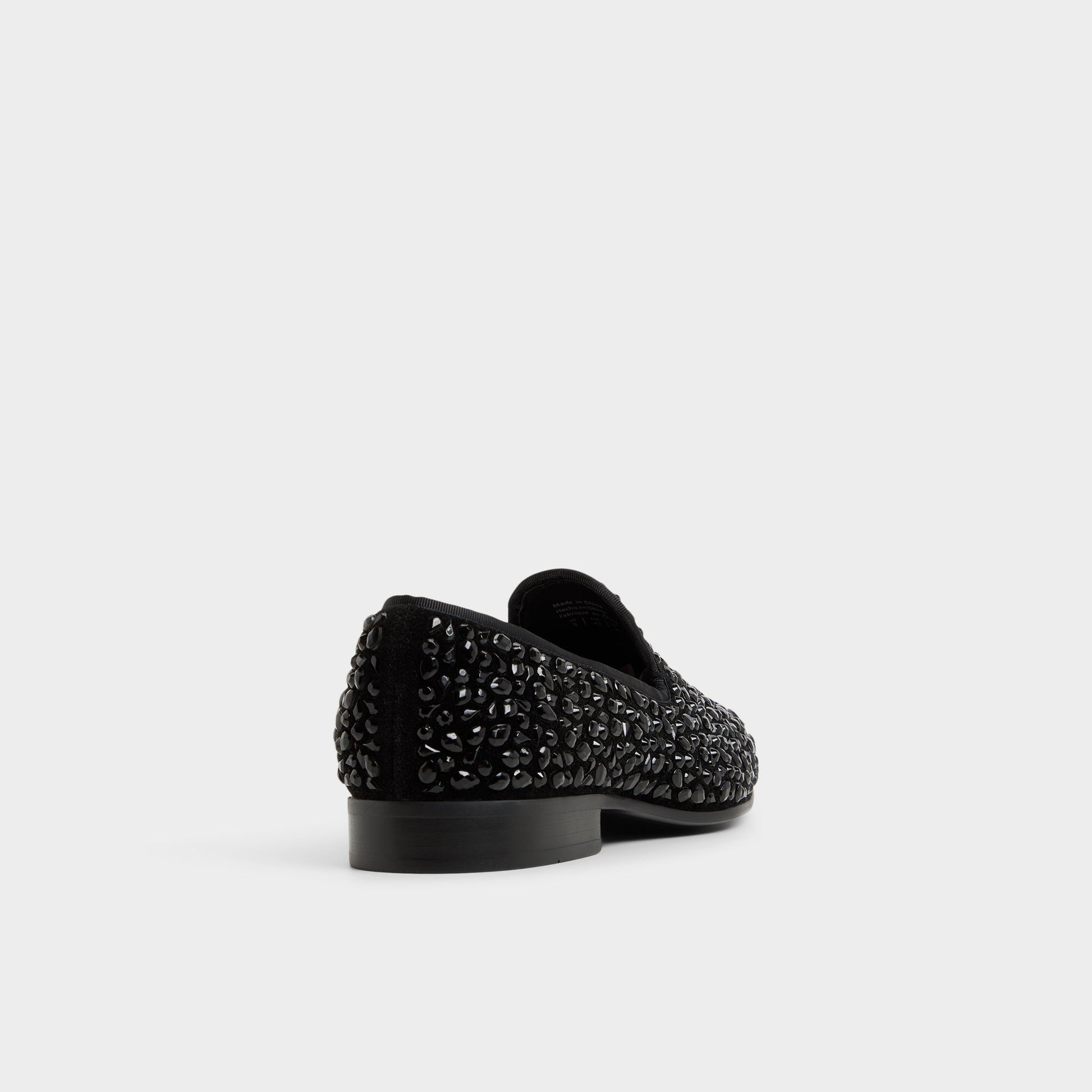 Three-quarter angle of Black Lux Slip-on's back side