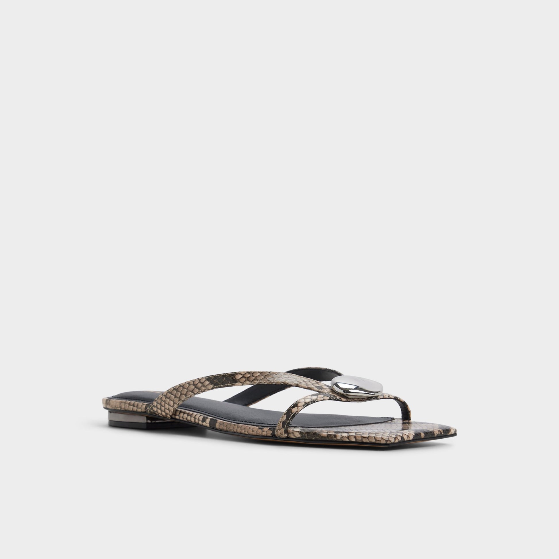 Three-quarter angle of White/black Iliria Slide sandal's front side