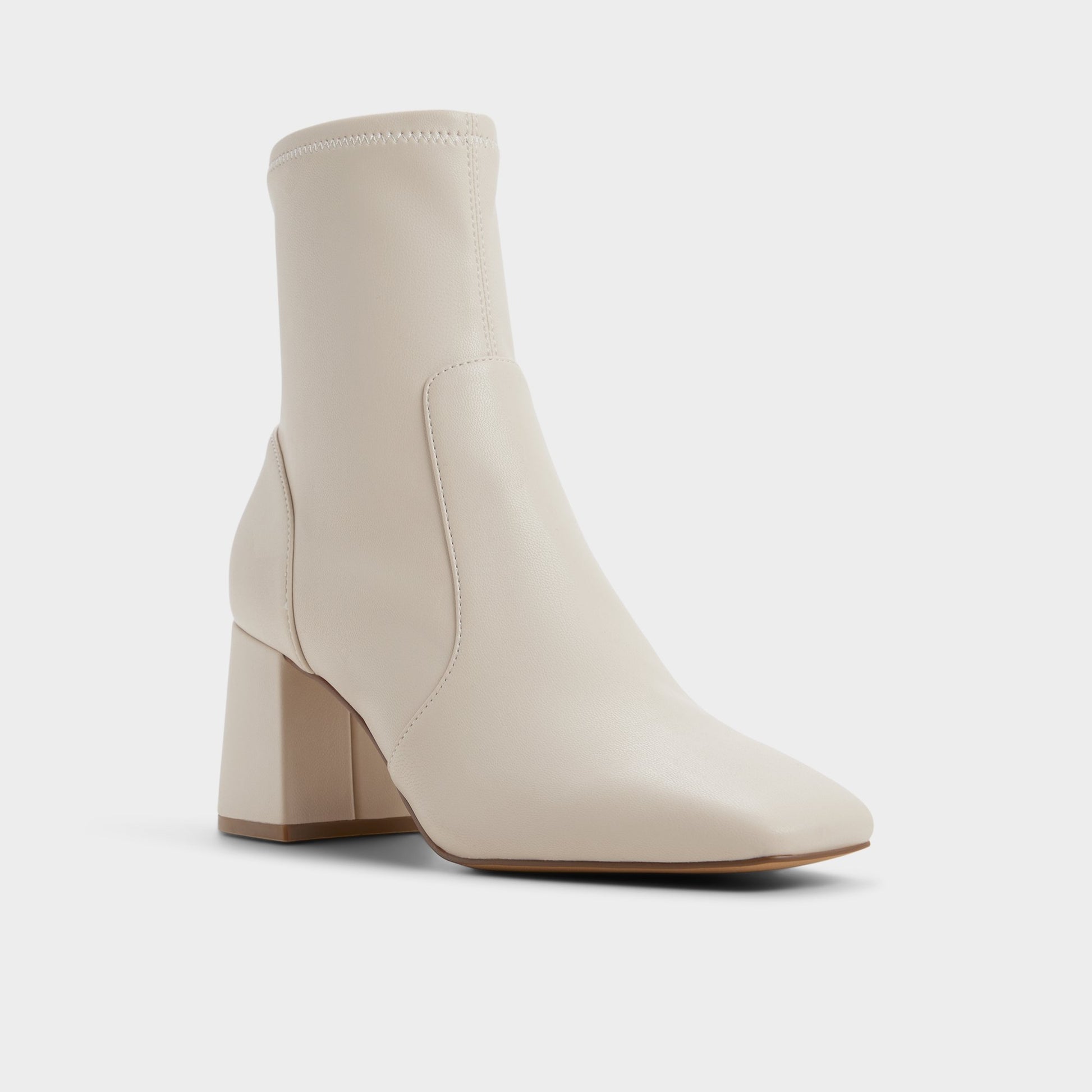 Three-quarter angle of White/Bone Indigo Ankle boot's front side