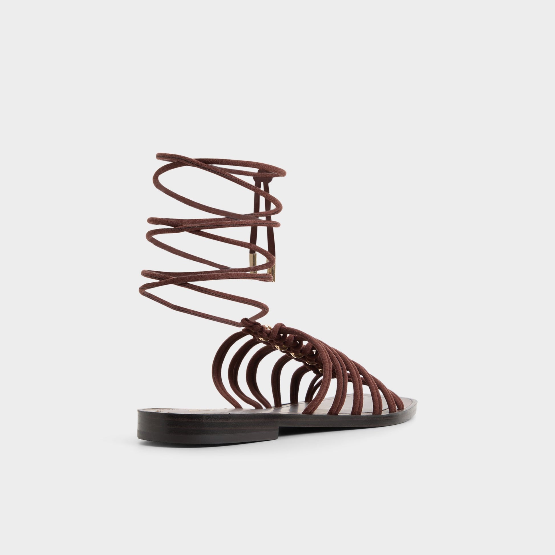Three-quarter angle of Dark brown Unoma Strappy flat sandal's back side