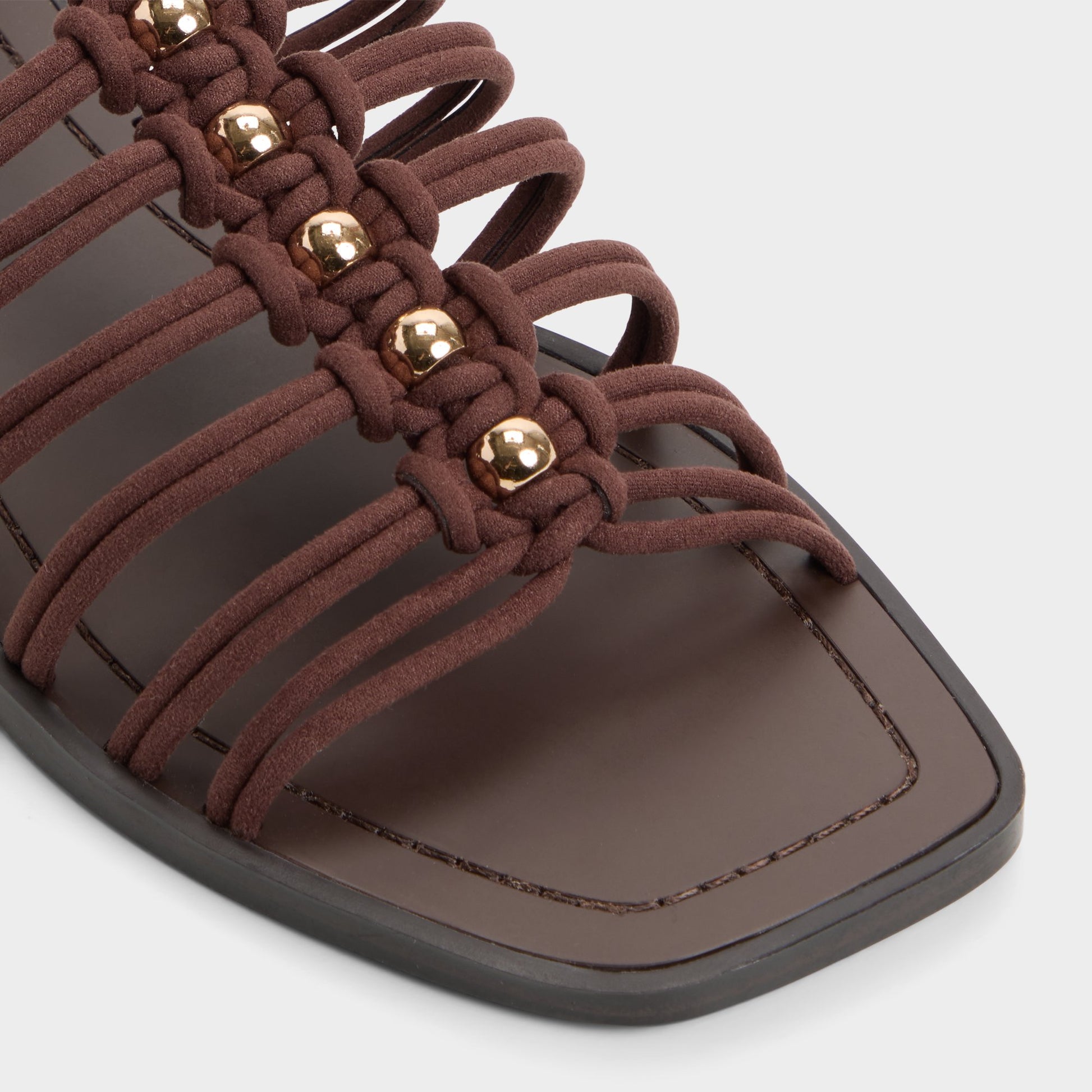 Close-up of the Dark brown Unoma Strappy flat sandal
