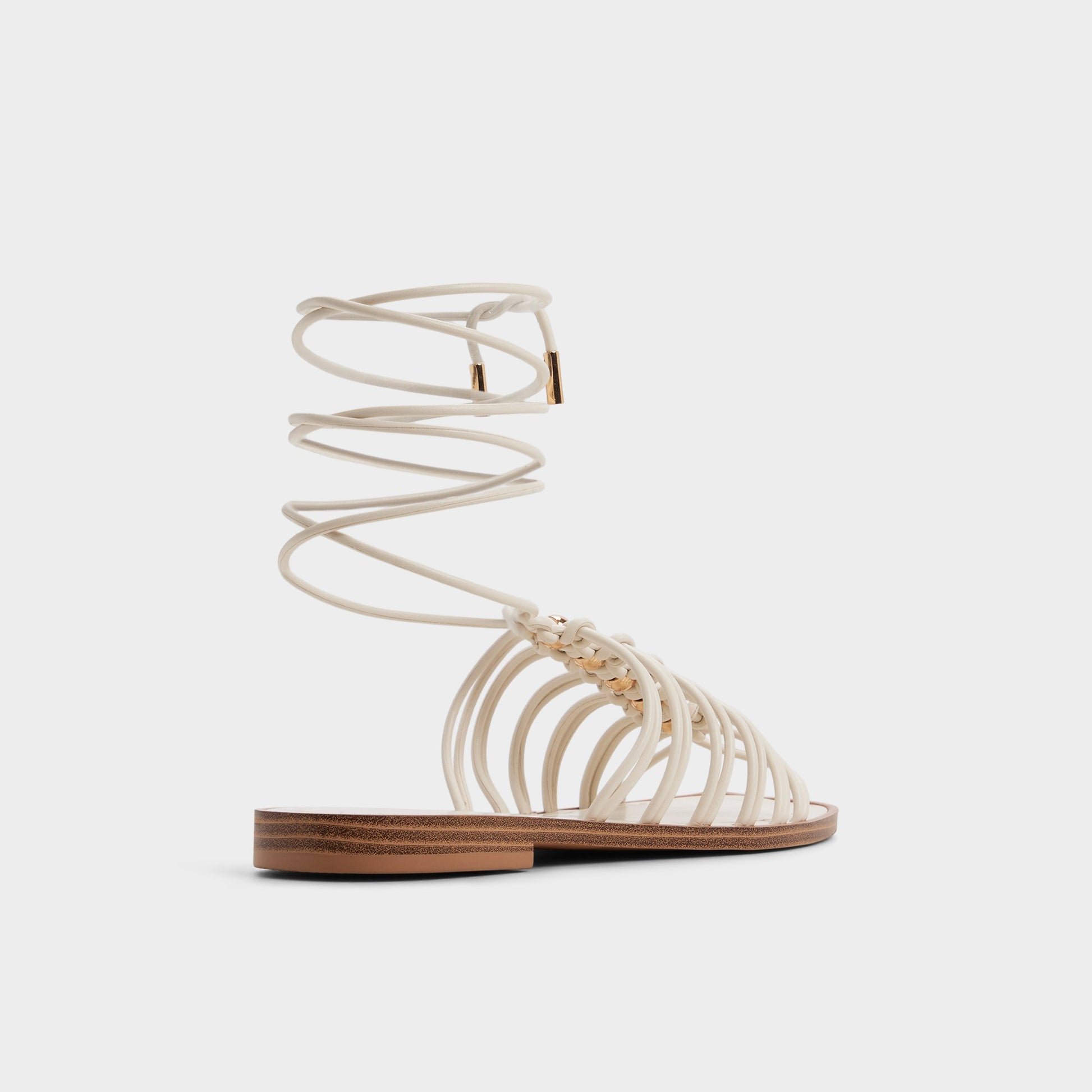 Three-quarter angle of White/bone Unoma Strappy flat sandal's back side