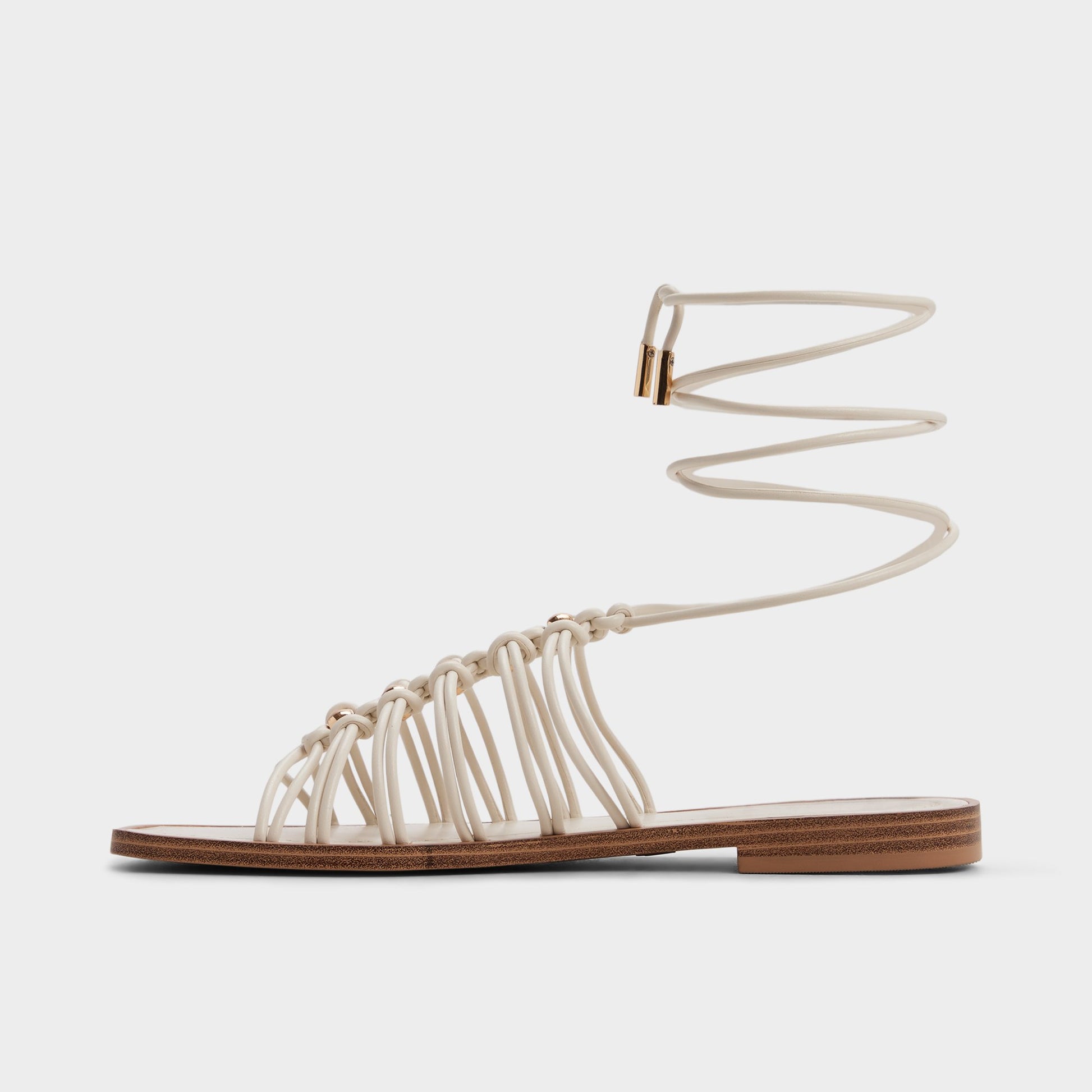 Side view of White/bone Unoma Strappy flat sandal