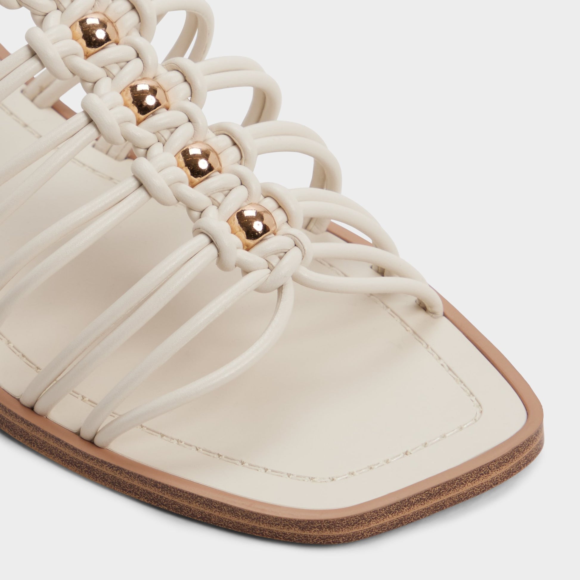 Close-up of the White/bone Unoma Strappy flat sandal