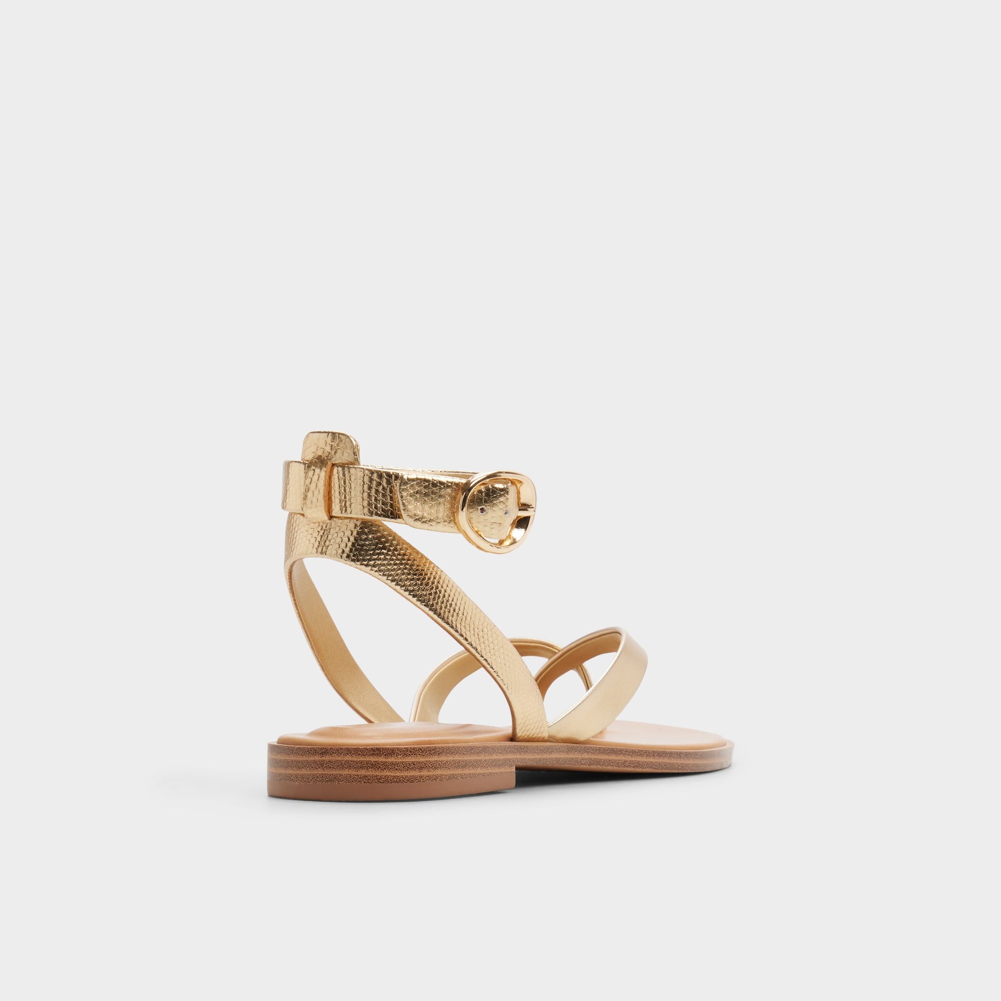 Three-quarter angle of Gold Daressi Flat sandal's back side