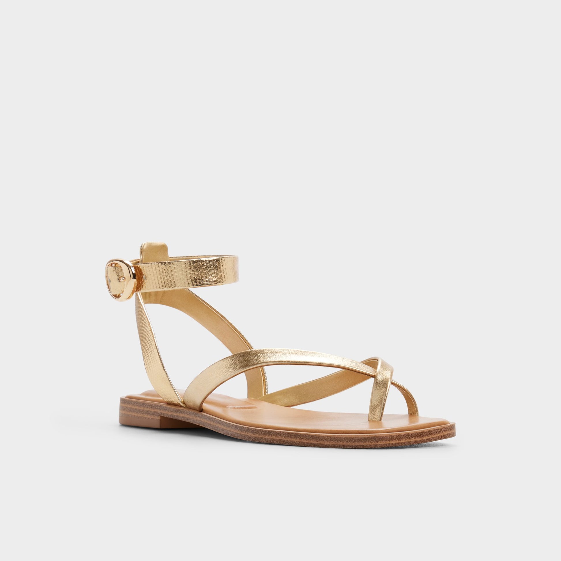 Three-quarter angle of Gold Daressi Flat sandal's front side
