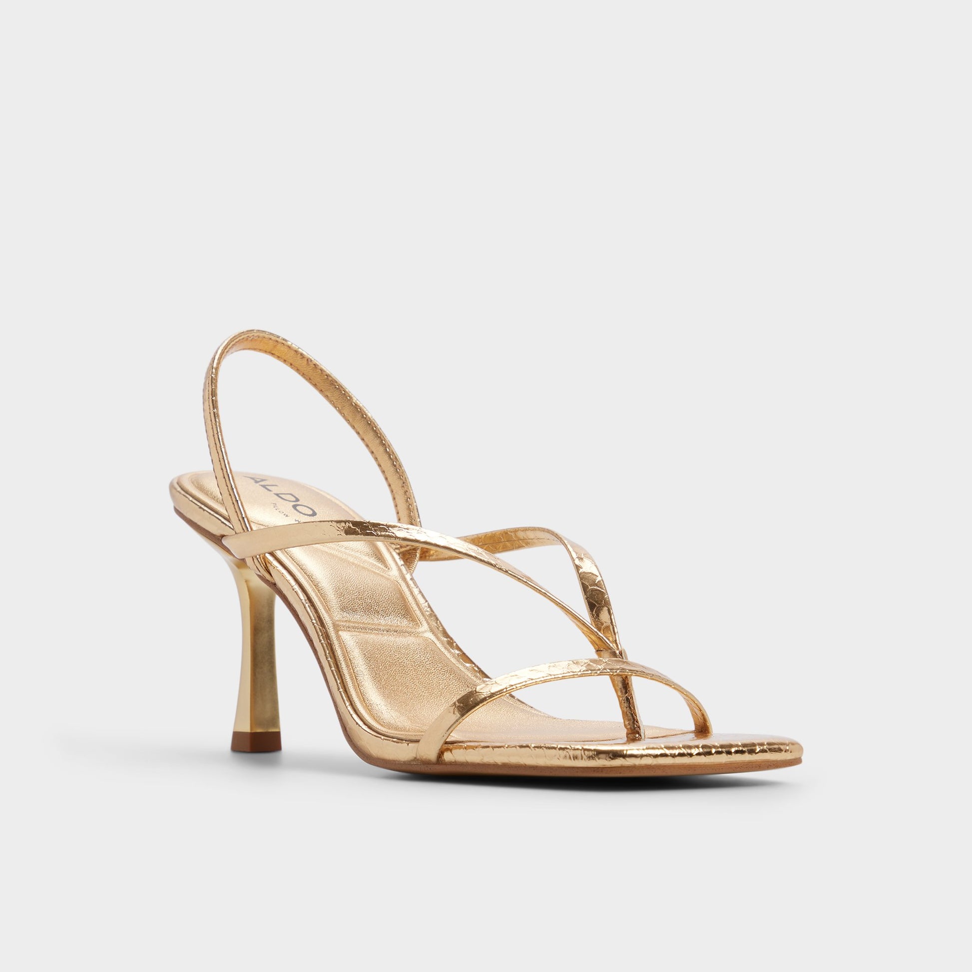 Three-quarter angle of Gold Riva Sling back heeled sandal's front side