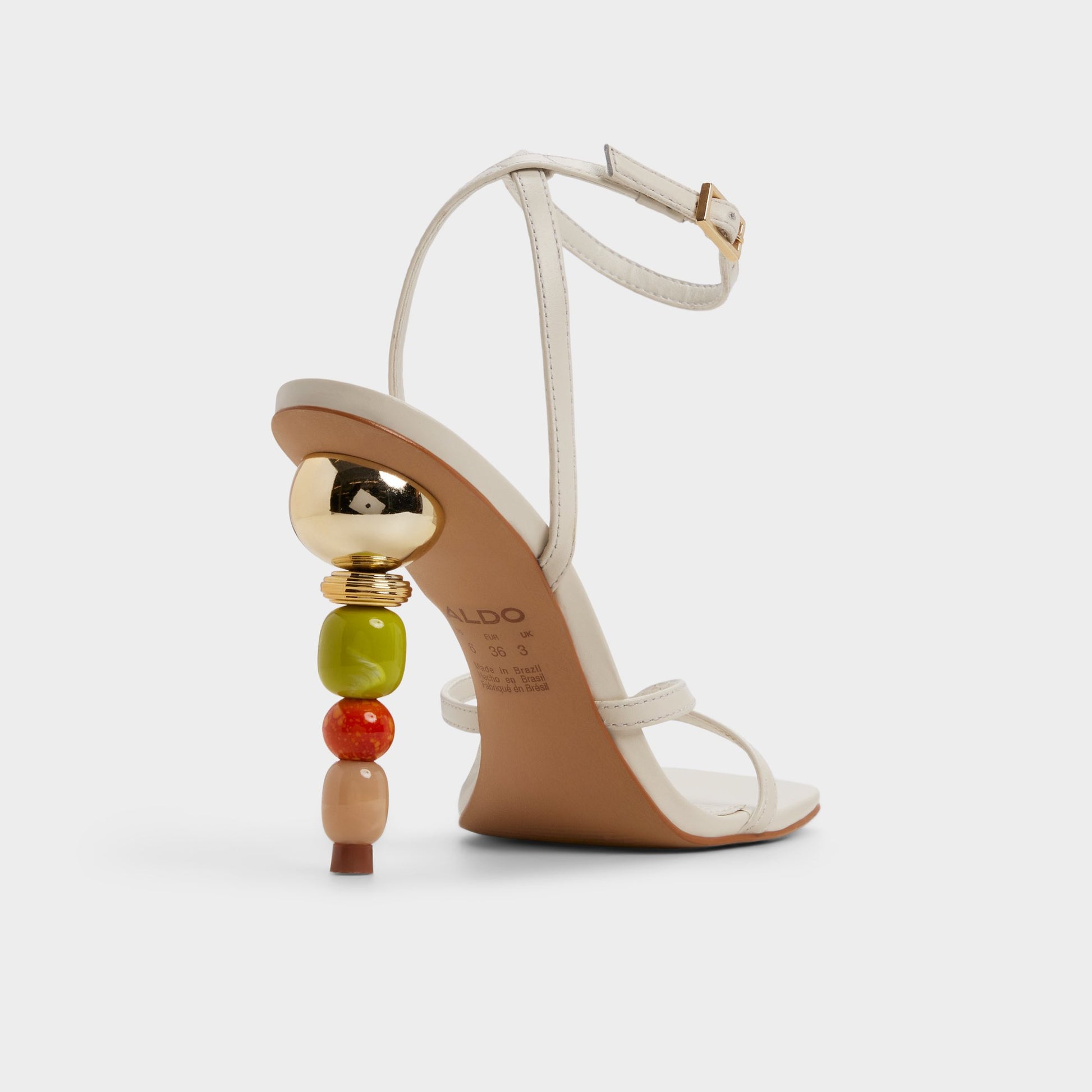 Three-quarter angle of White/bone Beachglass Strappy heeled sandal's back side